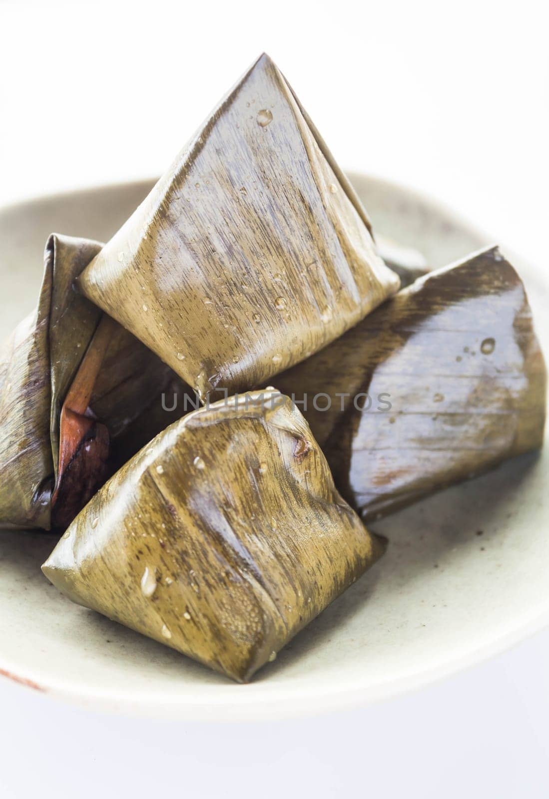 Stuffed dough pyramid dessert on dish, stock photo