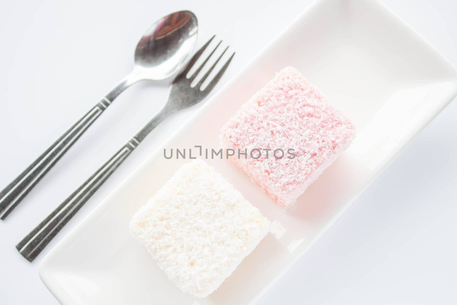 Set of pink and white lamington sponge cakes, stock photo