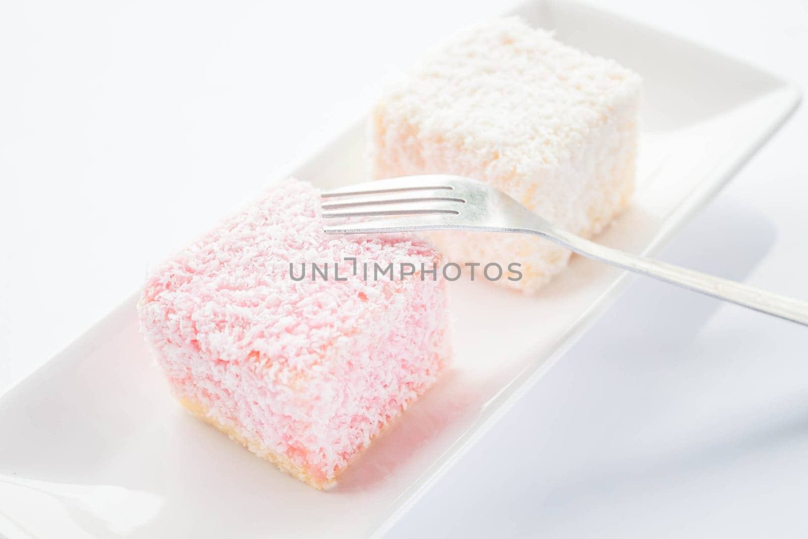 Lamington sponge cakes and fork, stock photo
