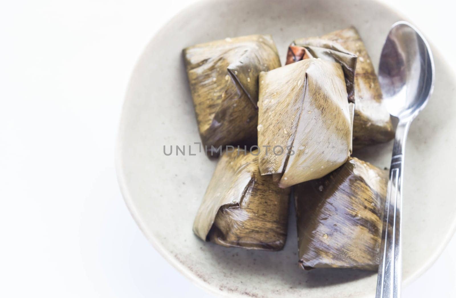 Thai dessert stuffed dough pyramid and spoon, stock photo