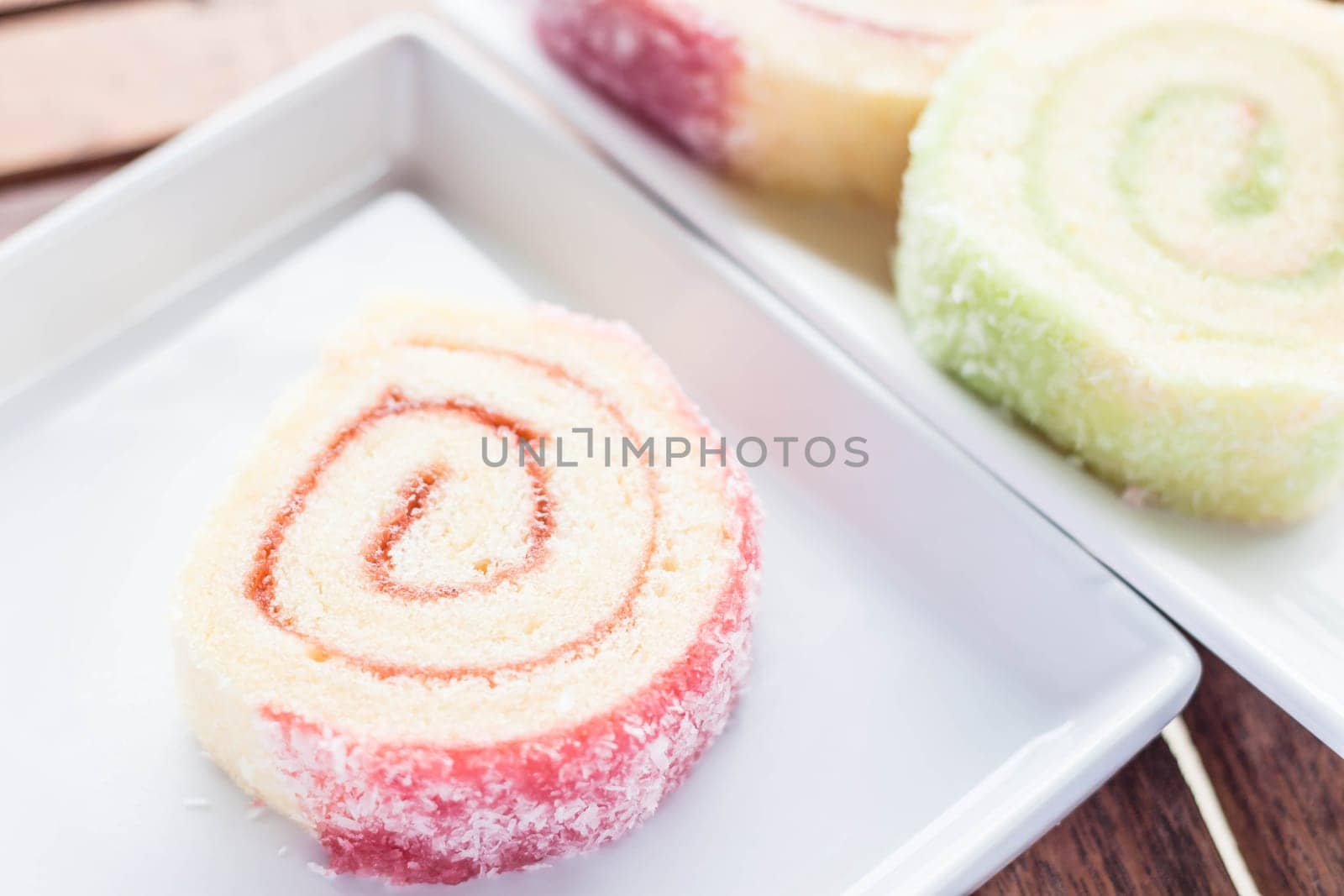 Colorful jam rolls served on white dish, stock photo