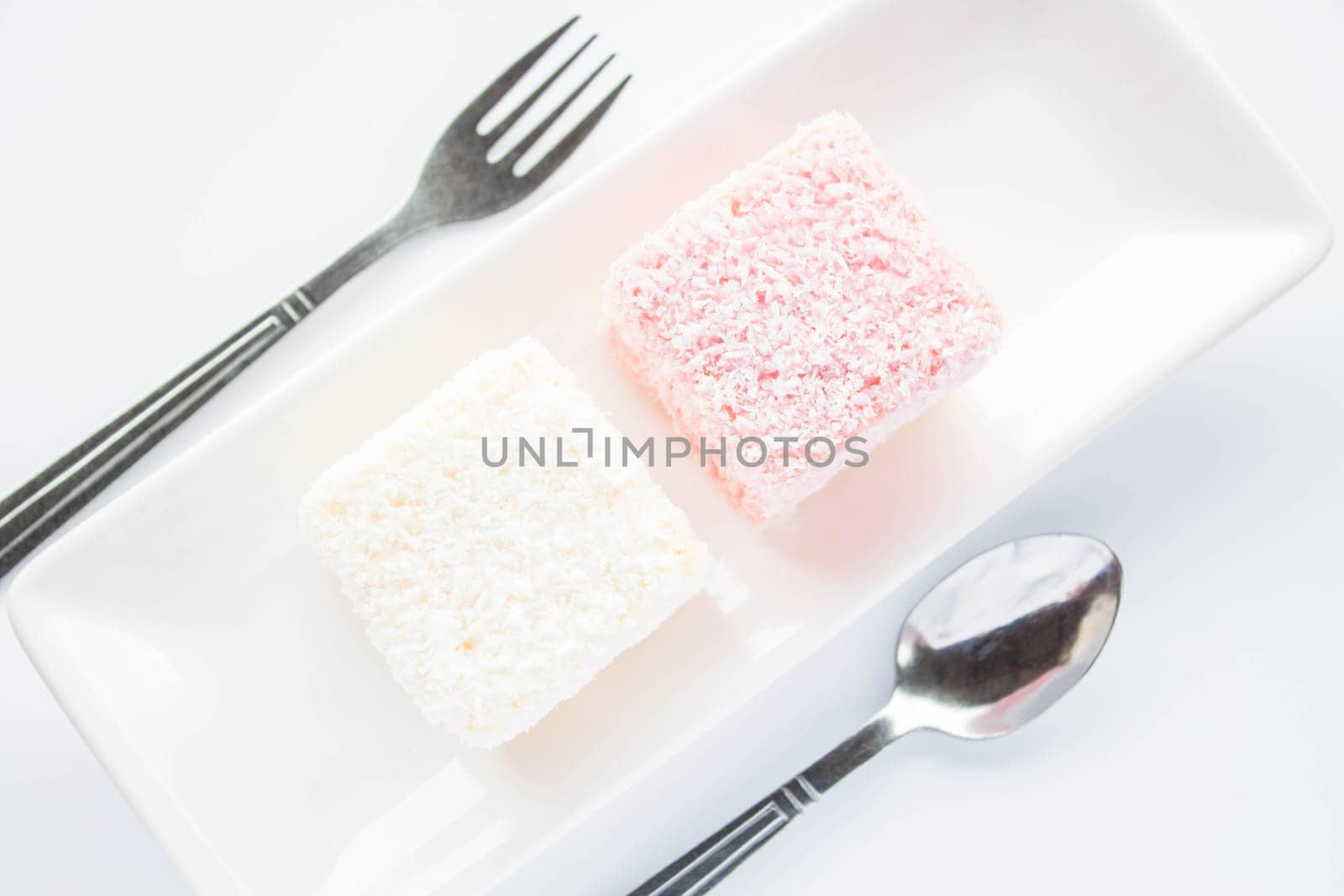 Pink and white lamington sponge cakes, stock photo