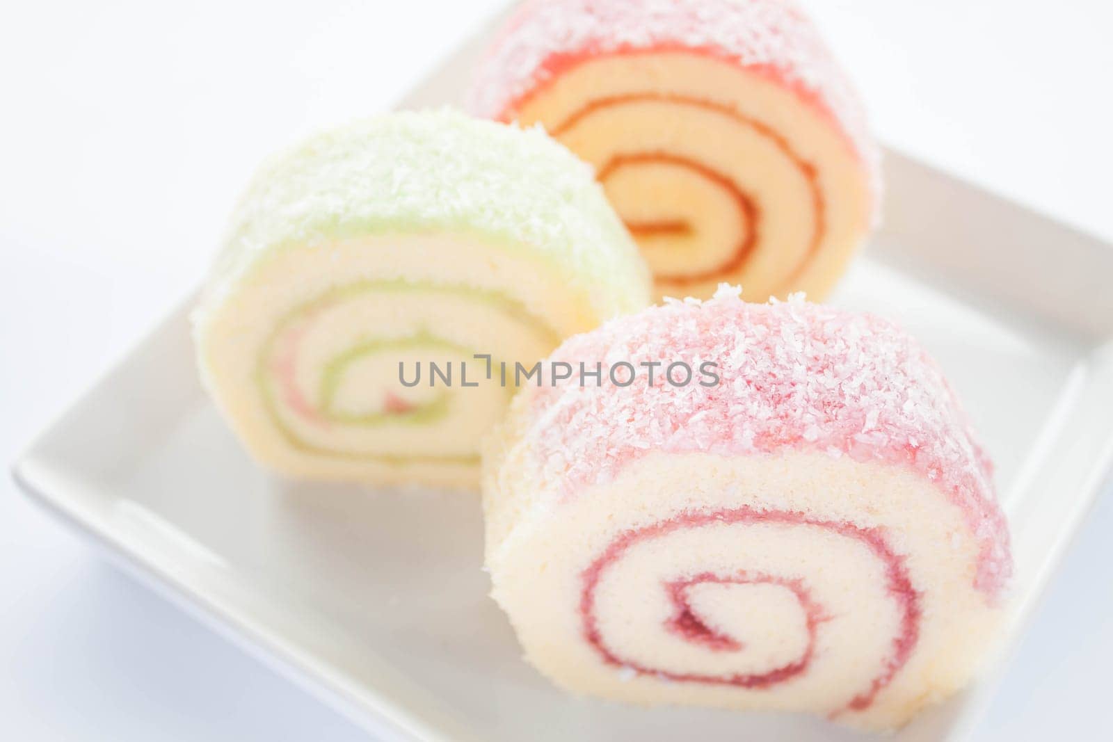 Colorful jam roll cakes  on white background , stock photo