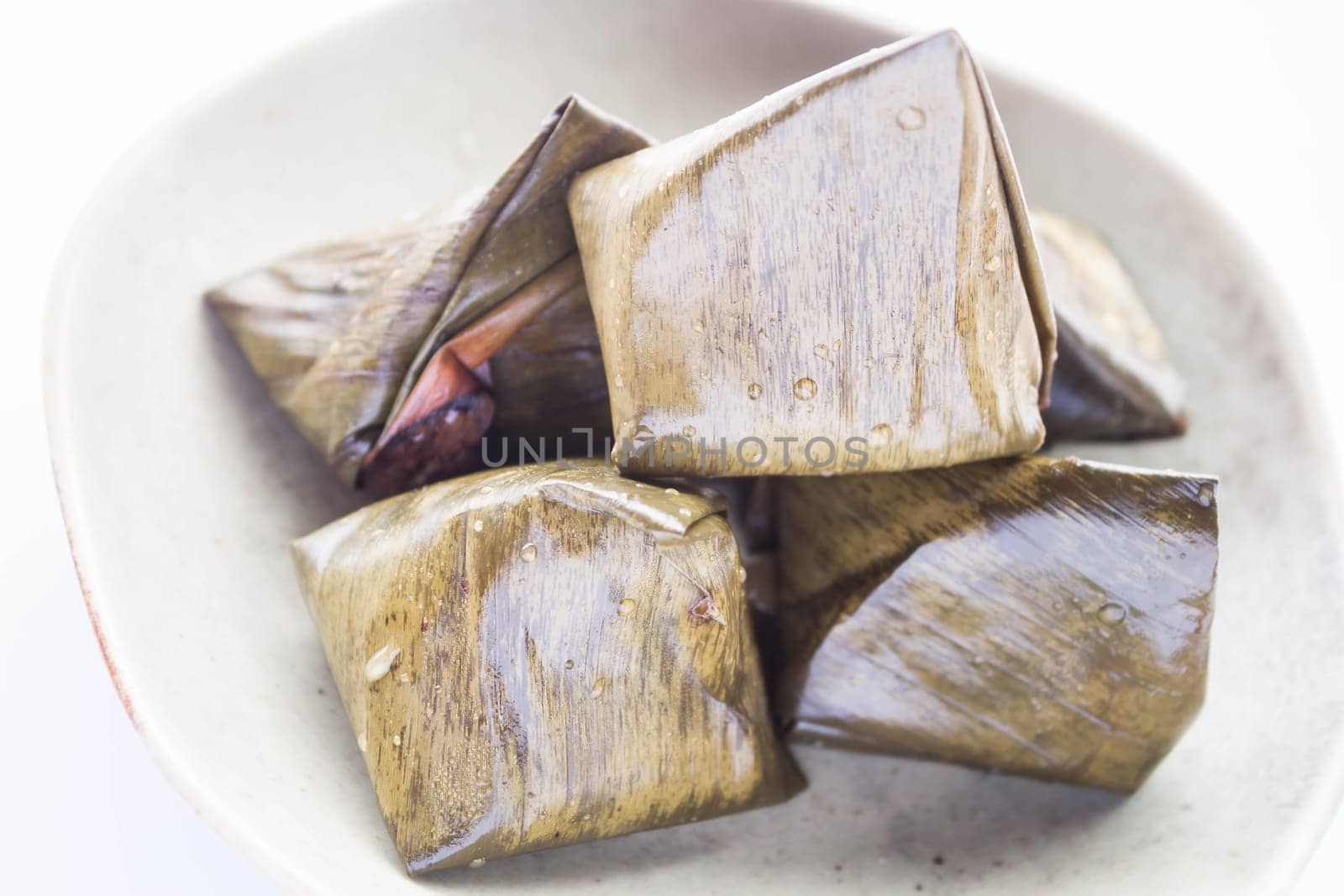 Stuffed dough pyramid dessert on plate up close, stock photo