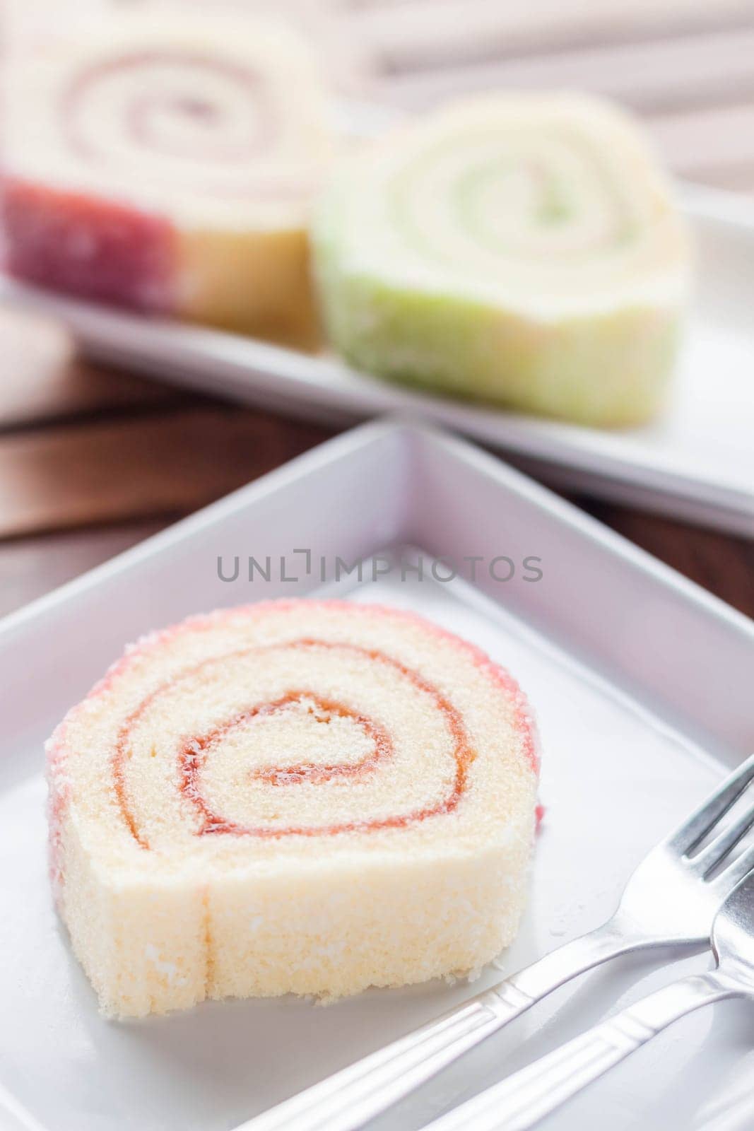 Colorful jam rolls served in restaurant, stock photo