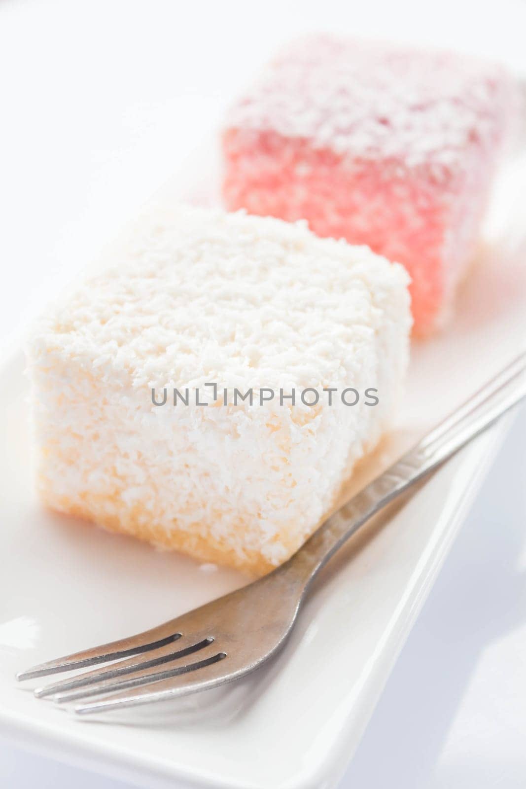 Close up lamington sponge cakes and fork, stock photo