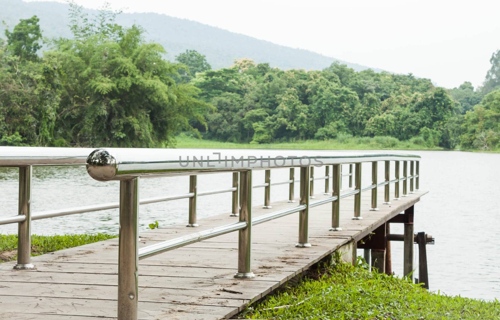 Metal bridge into the lake, stock photo