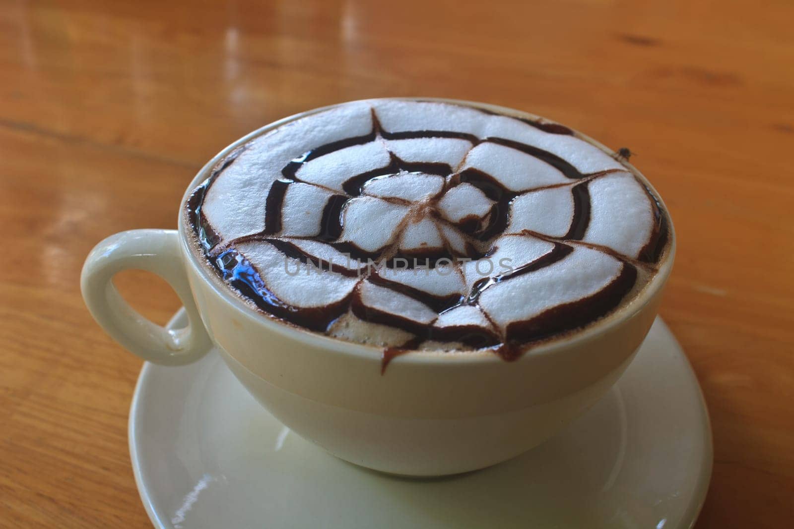 Cup of cappuccino coffee on wooden table