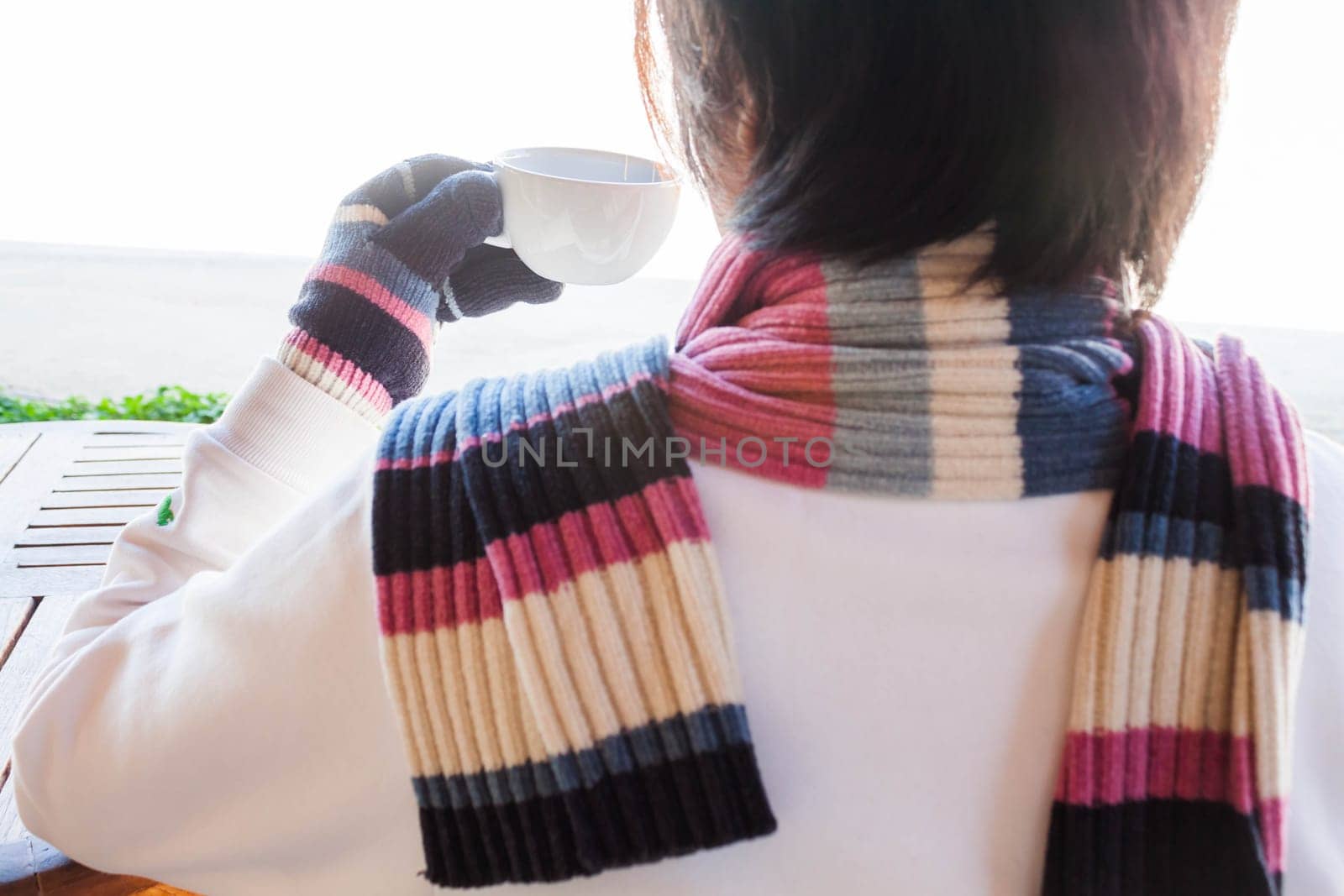 Drinking hot cup of coffee in winter, stock photo