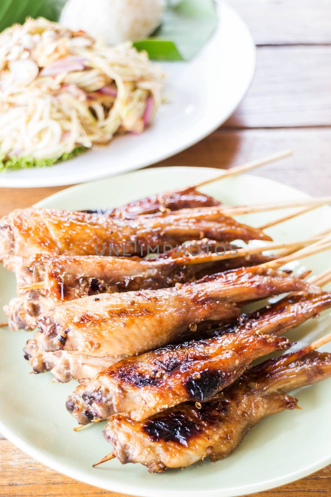 Grilled chicken serving with papaya salad, stock photo