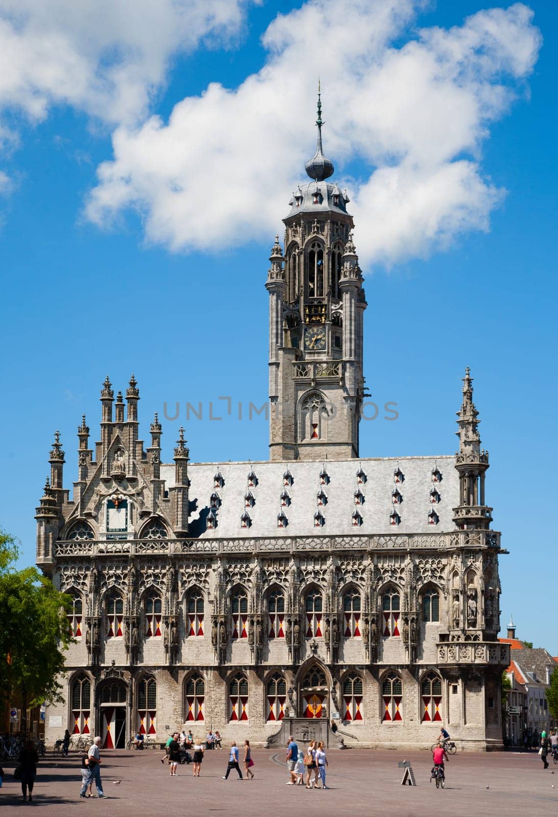 MIDDELBURG, THE NETHERLANDS - JULY 1, 2014  Unidentified people in front of the famous city hall of Middelburg on July 1 in Middelburg, Zeeland, The Netherlands, .