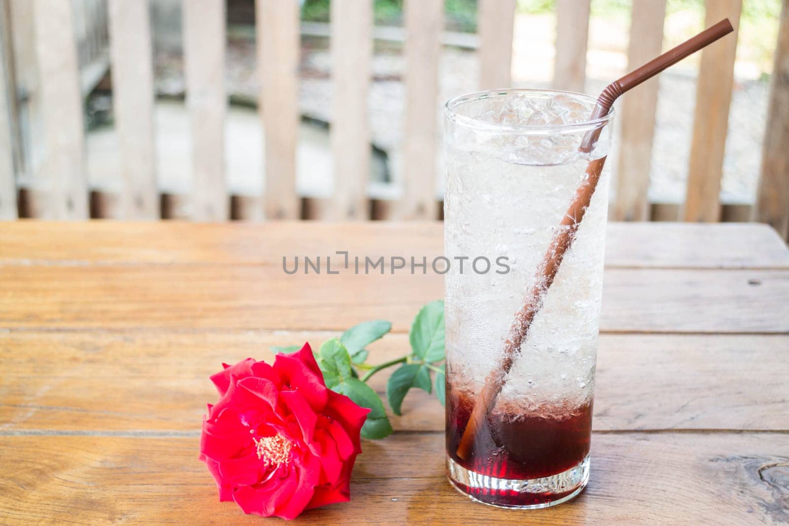 Iced pomegranate drink on wood table, stock photo