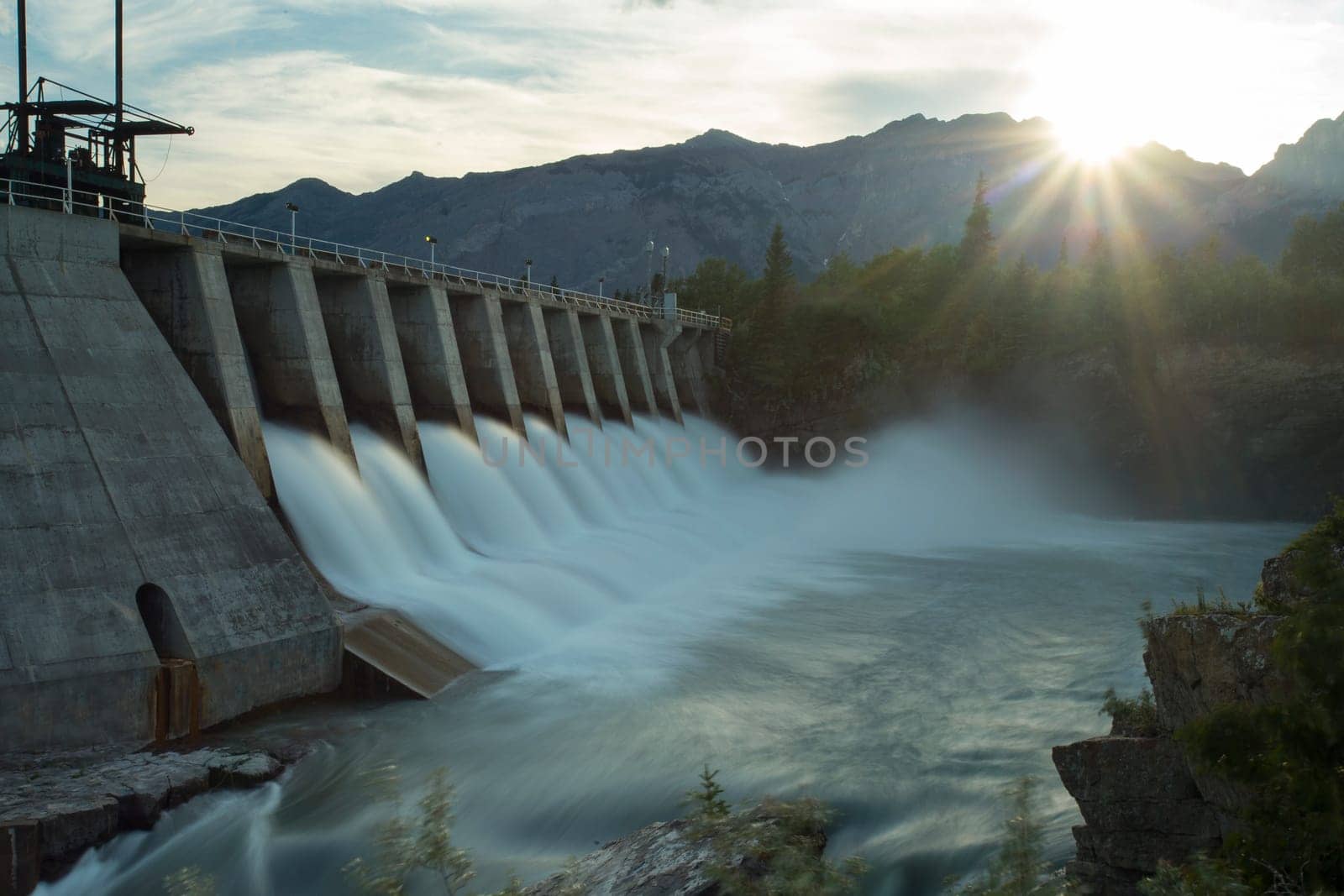 Wide shot time exposure of the spillway on the Kananaskis hydroelectric dam on the Bow River, with Canadian Rocky Mountains, Alberta, Canada