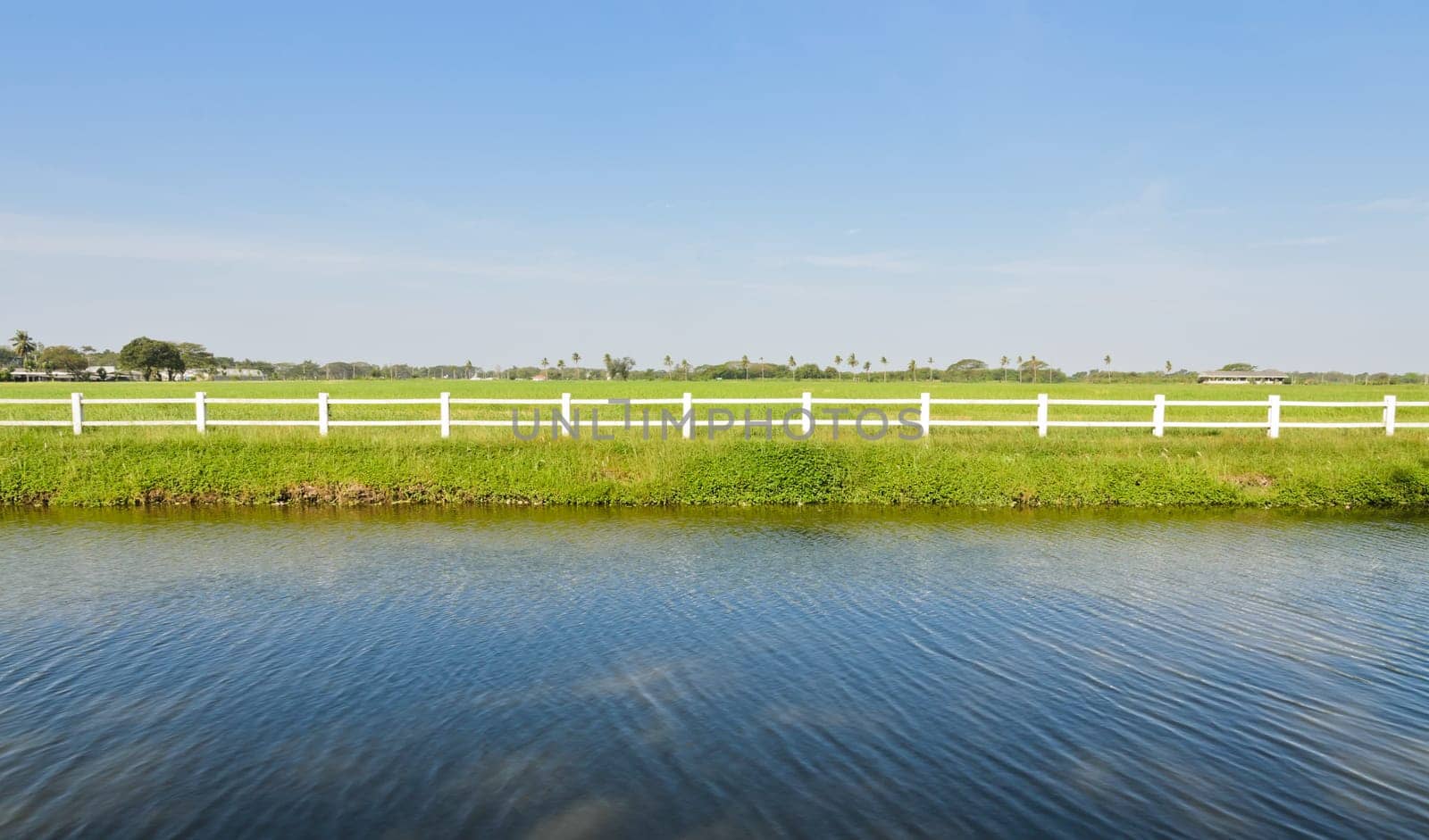 White fence with green field