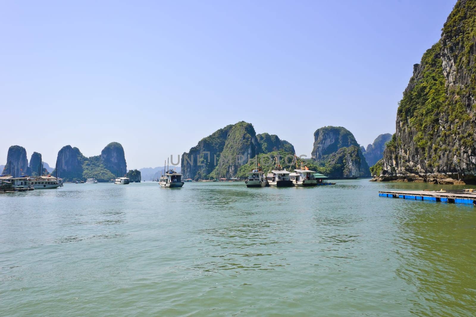 Tourist boats at floating fishing village in Halong bay, Vietnam