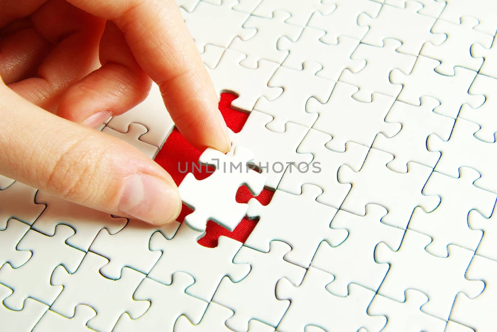 hands holding a puzzle piece . business concepts
