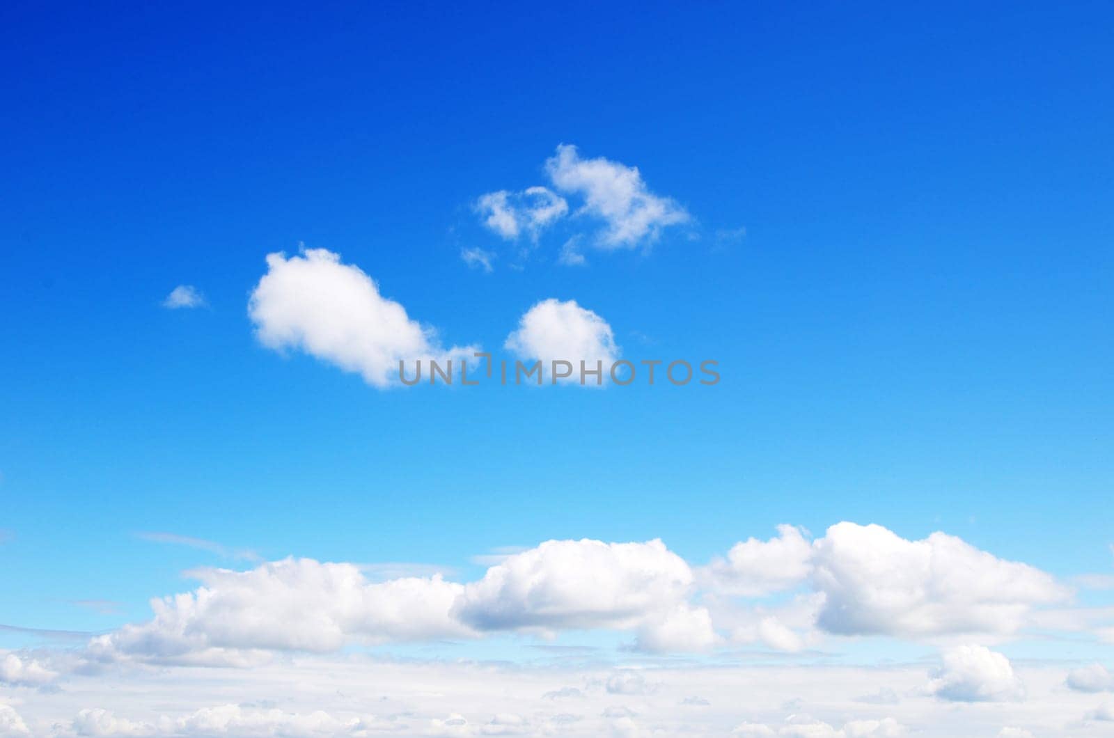 blue sky background with tiny clouds