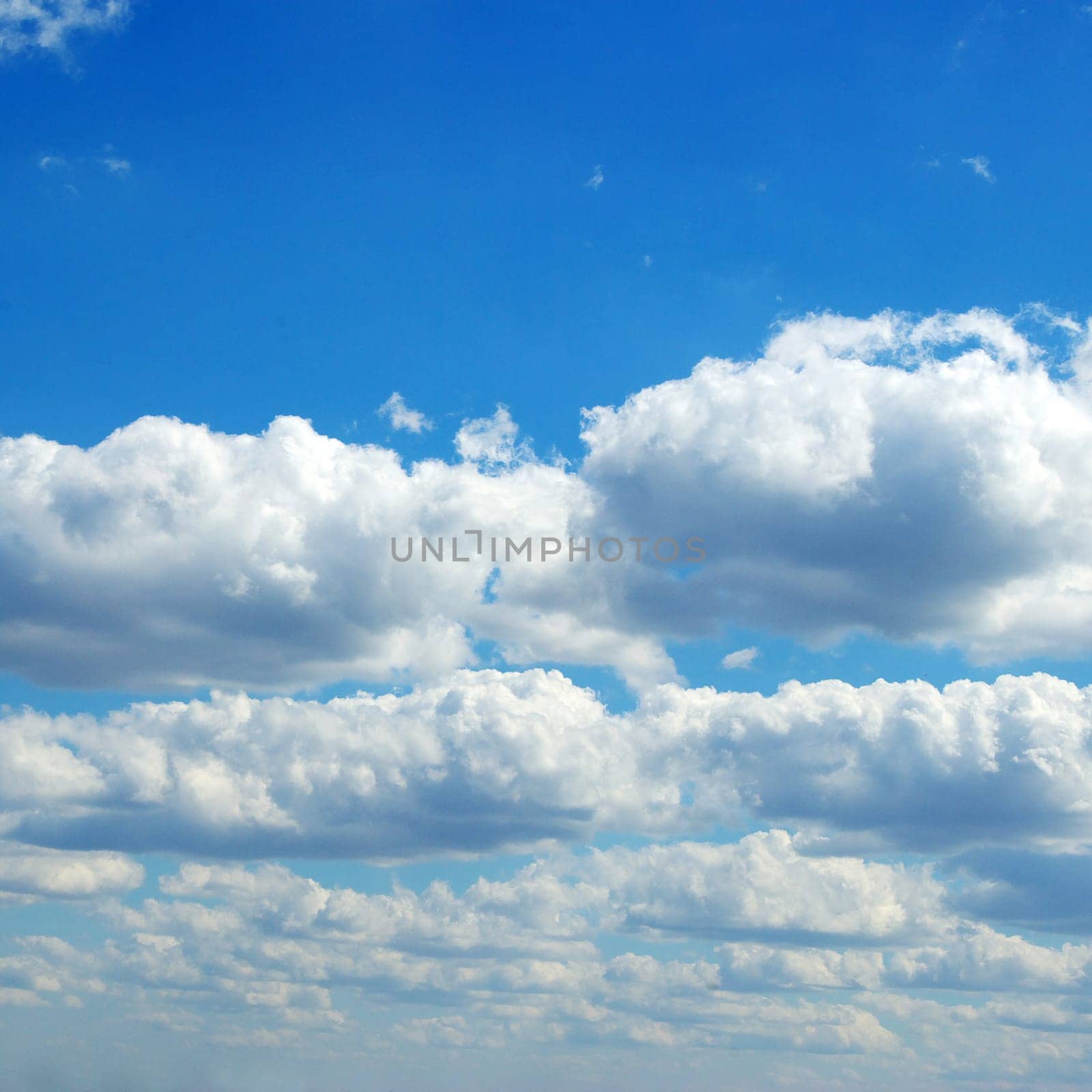 Blue sky background with tiny clouds