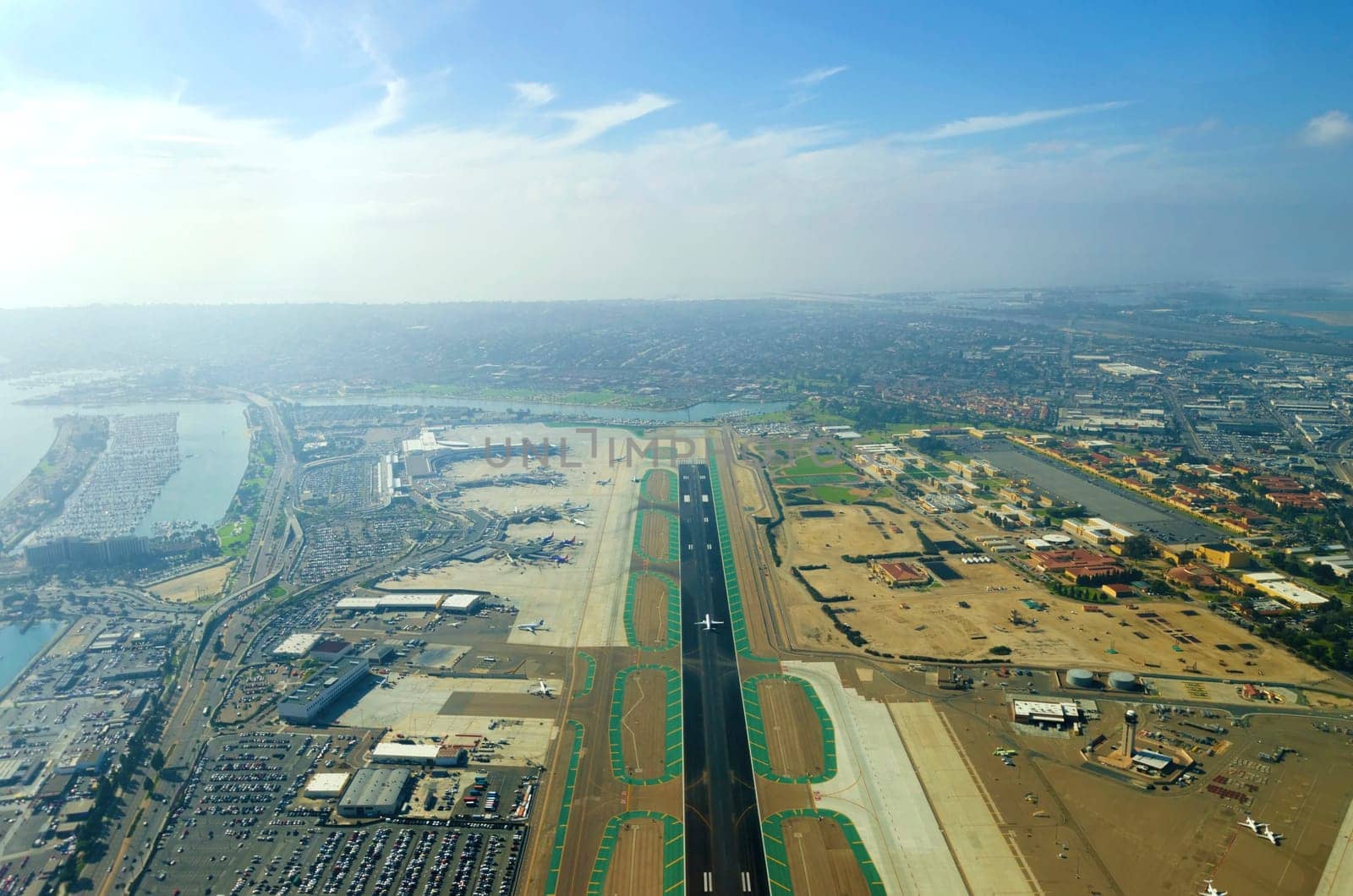 Aerial view of the San Diego International Airport, river and pacific ocean, in Southern California. Lindbergh Field is the busiest single runway commercial airport in the United States of America.