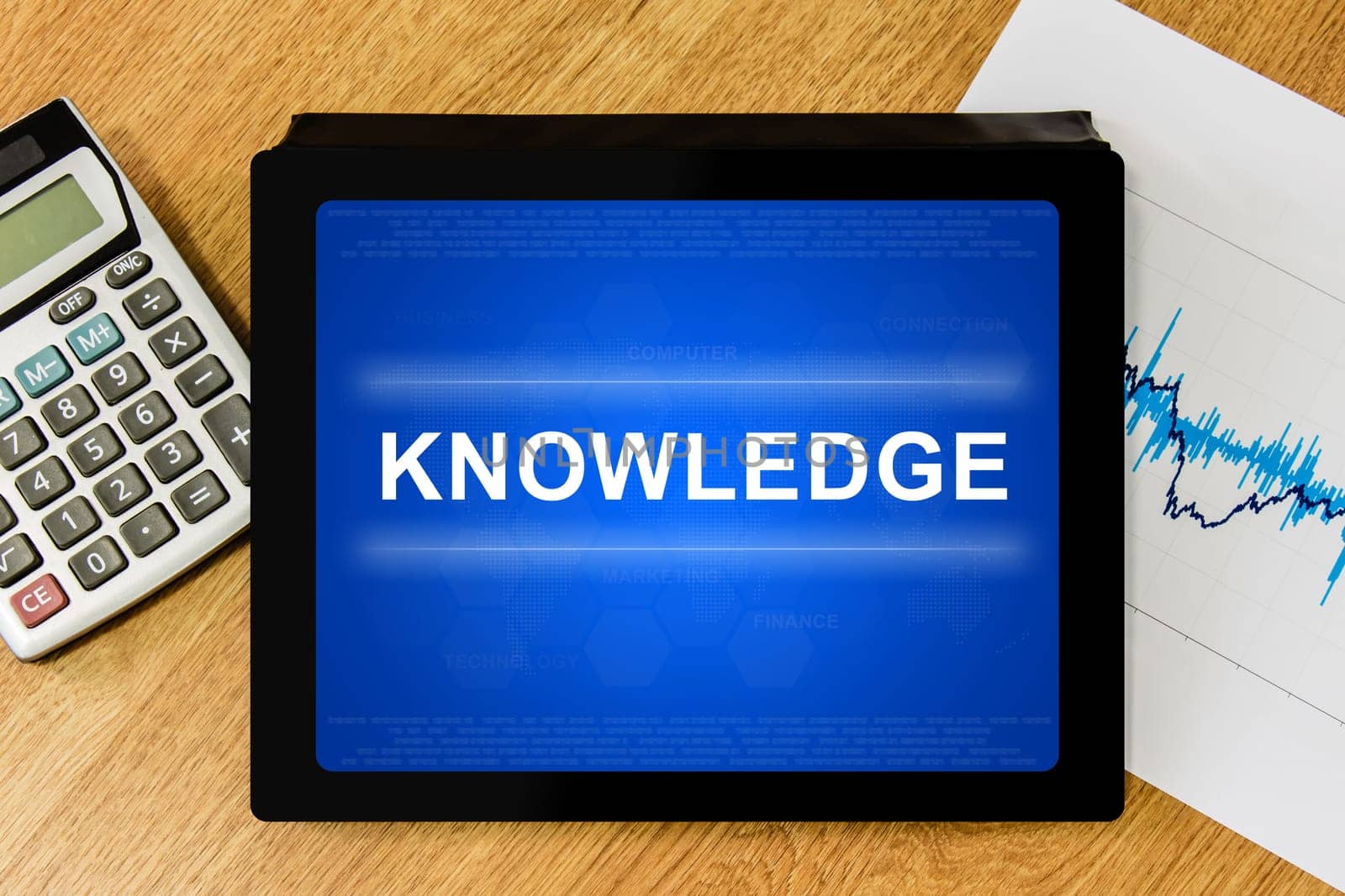 knowledge word on digital tablet with calculator and financial graph