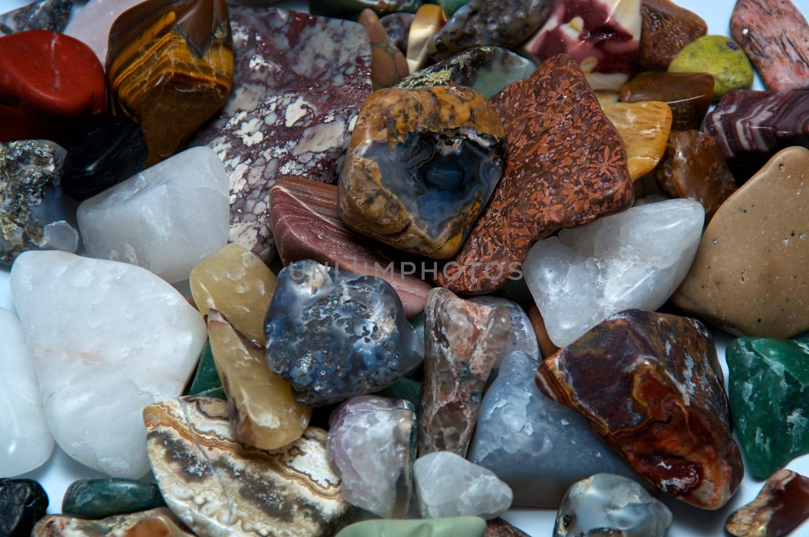 Close up of many different size, shape and colored tumbled stones