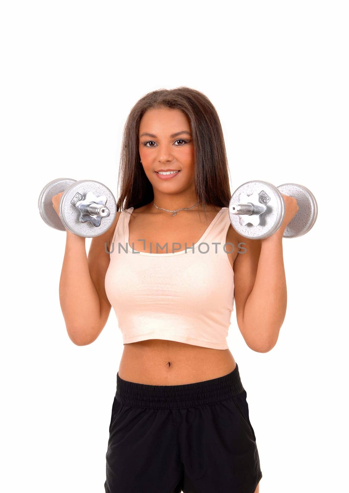 A pretty woman in black shorts standing isolated for white background lifting.two dumbbell's for exercise..