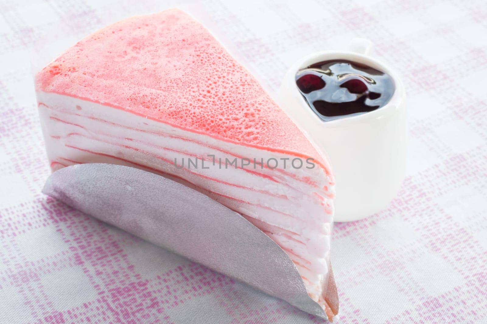Delicious crepe cake serving with blueberry sauce, stock photo