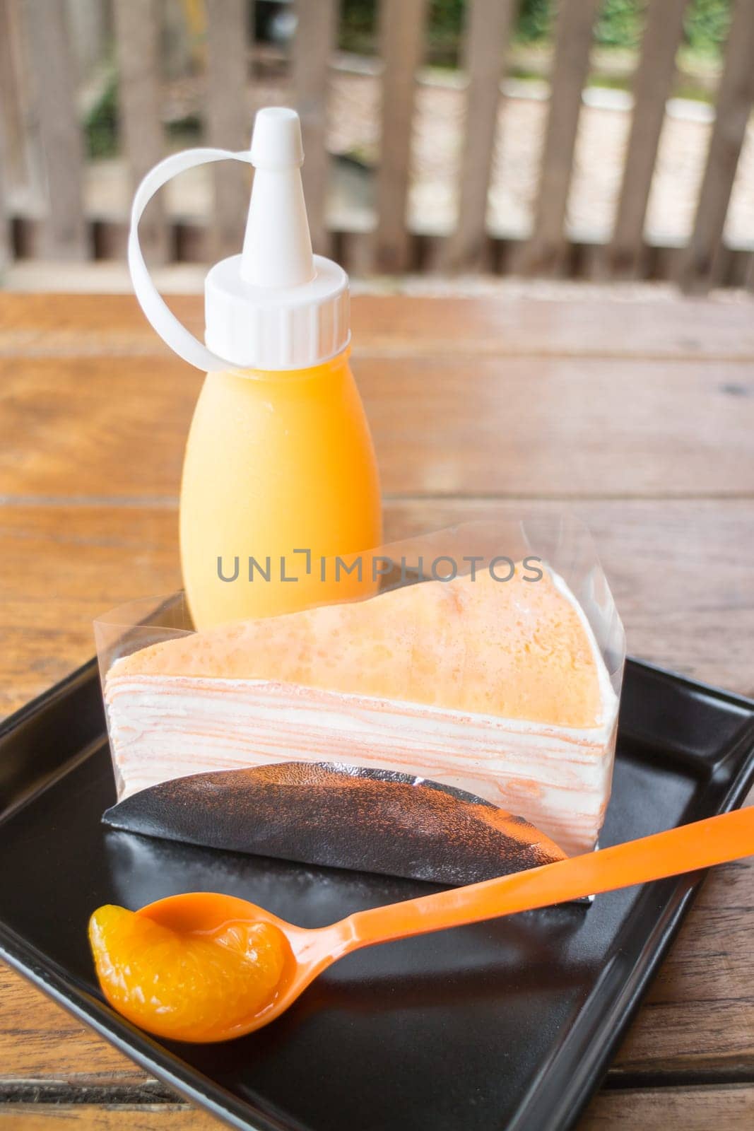 Whipped cream crepe cake with orange sauce, stock photo