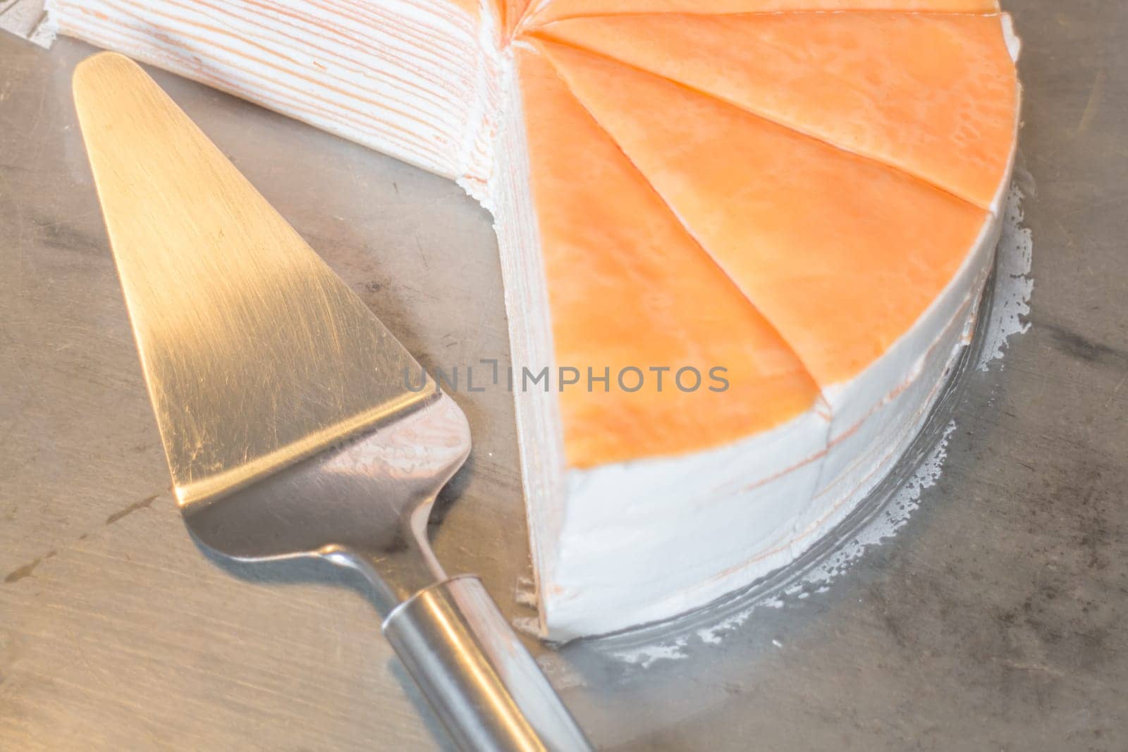 Piece of orange crepe cake, stock photo