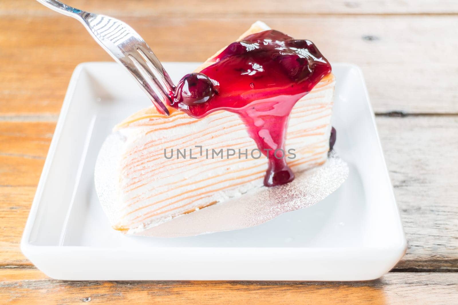 Melt blueberry sauce whipped cream crepe cake, stock photo