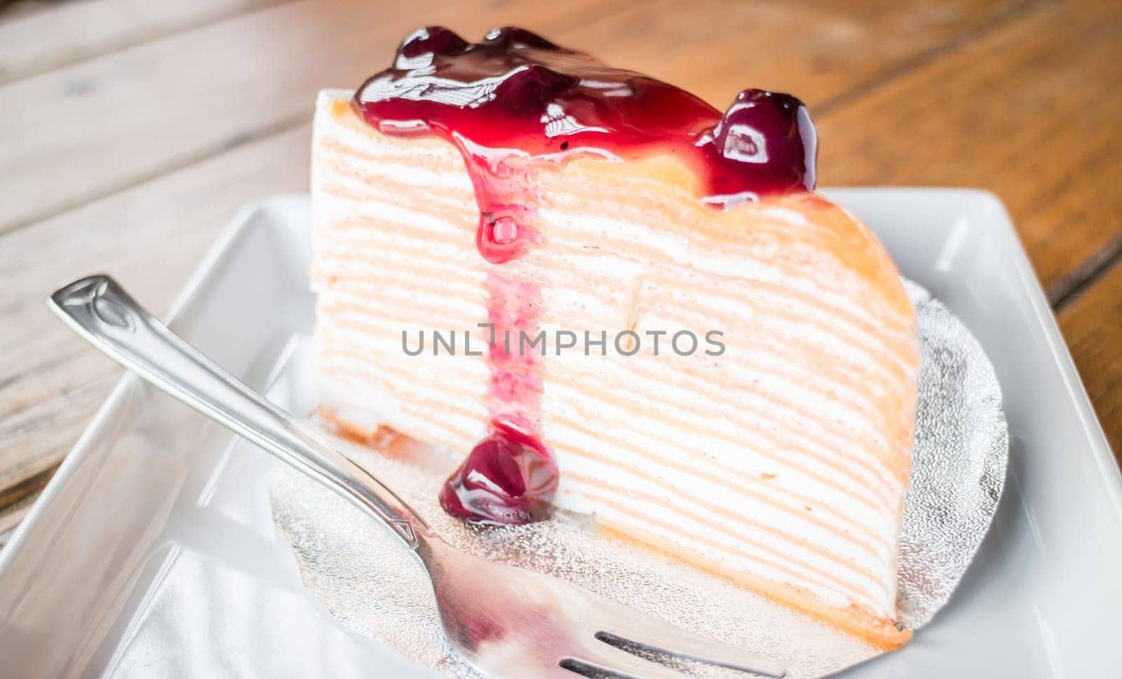 Delicious crepe cake with blueberry melt sauce, stock photo