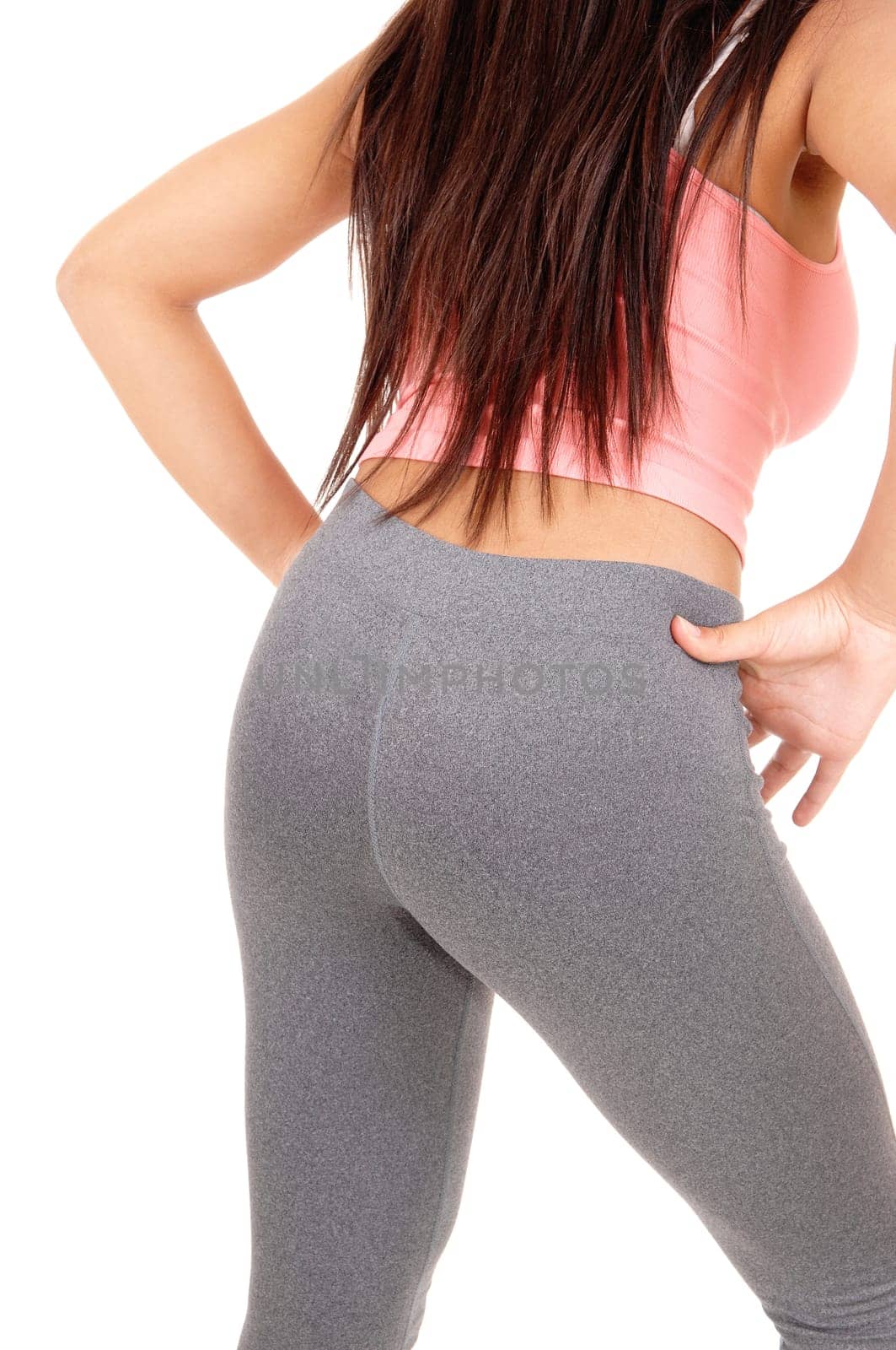 A young pretty woman standing from the back with her long brunette hair.and grey tights, isolated on white background..