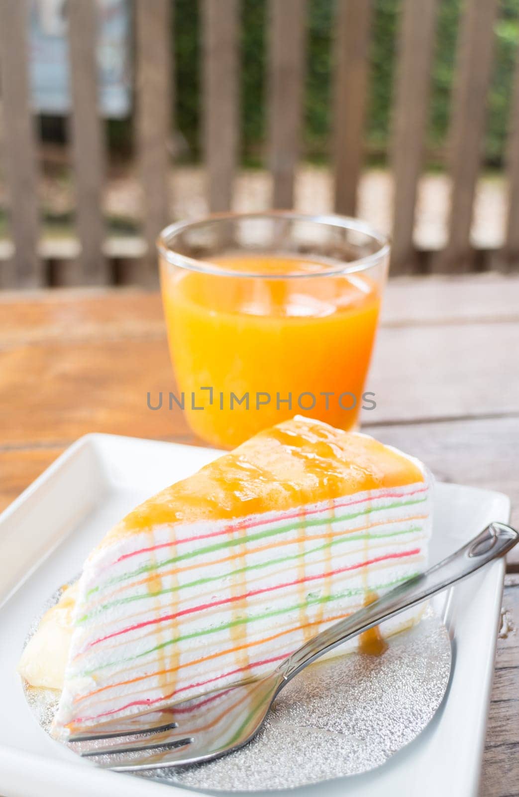 Banana caramel crepe cake and fresh orange juice, stock photo