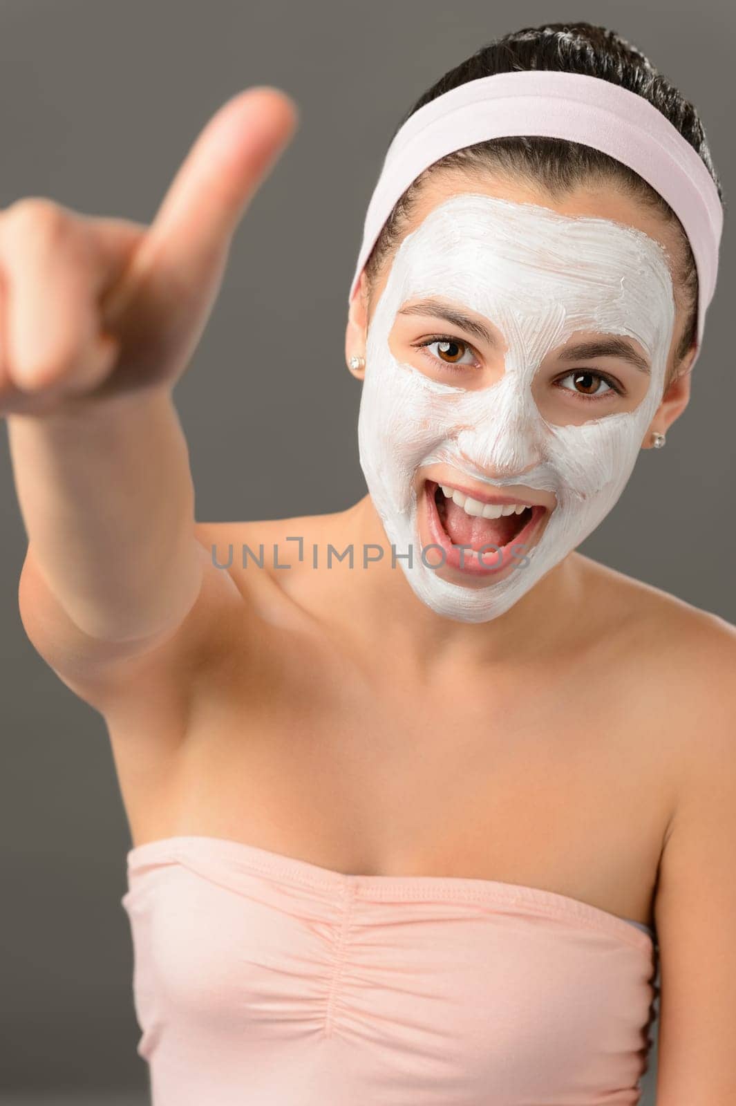 Teenage girl facial mask beauty thumb-up shouting on gray background