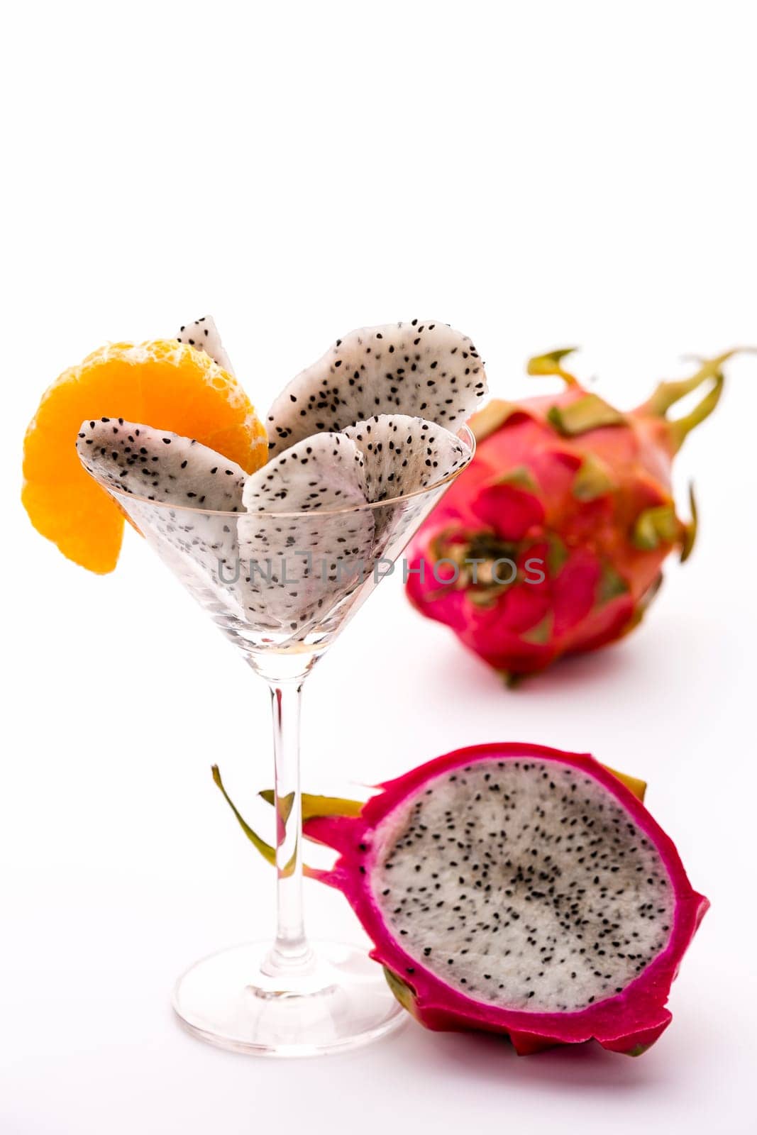Wedges of the dragon fruit assorted in a cocktail glass and adorned with mandarine disc,which is also in harmony as regards taste..