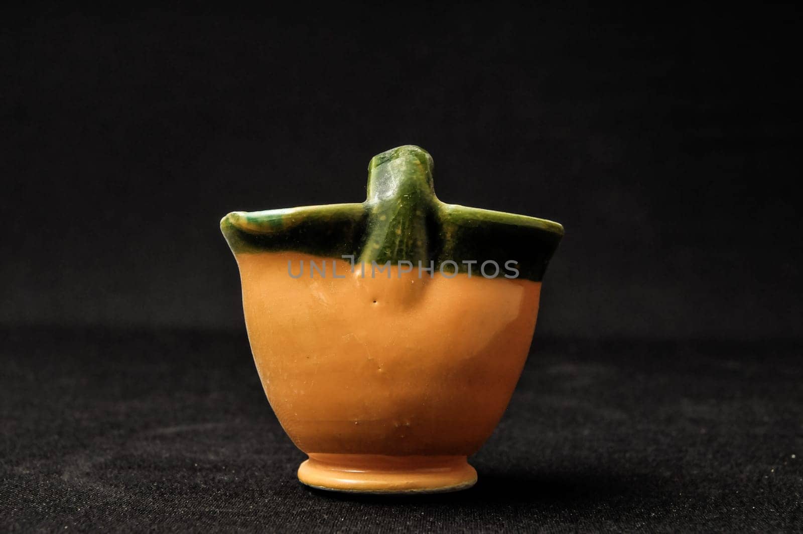 Colorful designed clay vase over a Black background