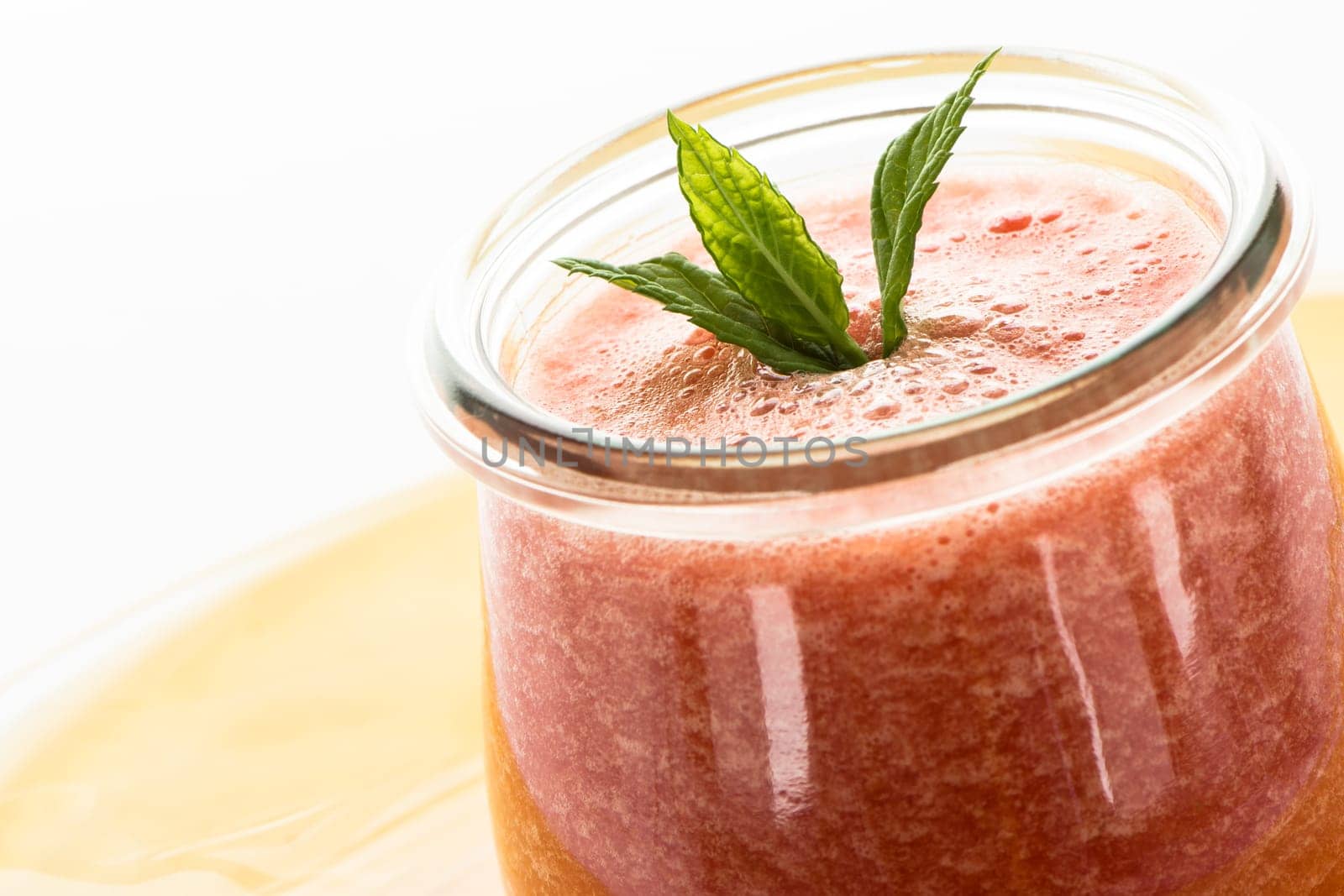 Red cold bowl with melon and peppermint in a glass