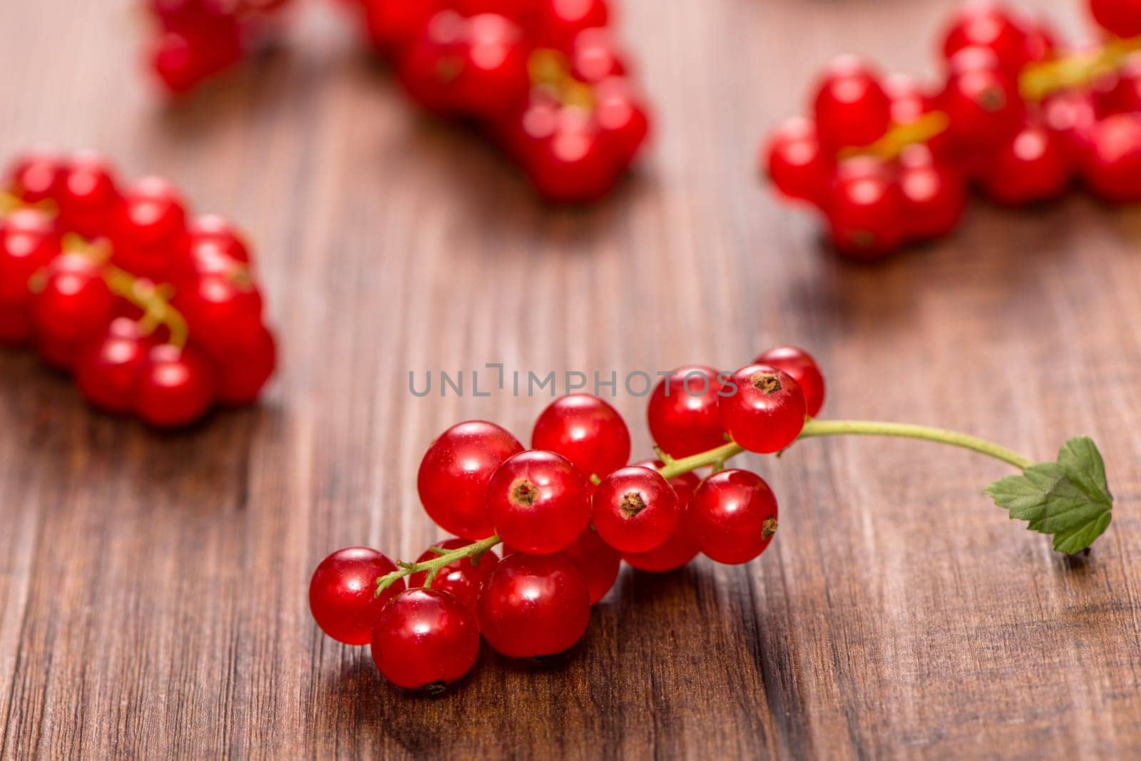 Red currants in the backlight on wood