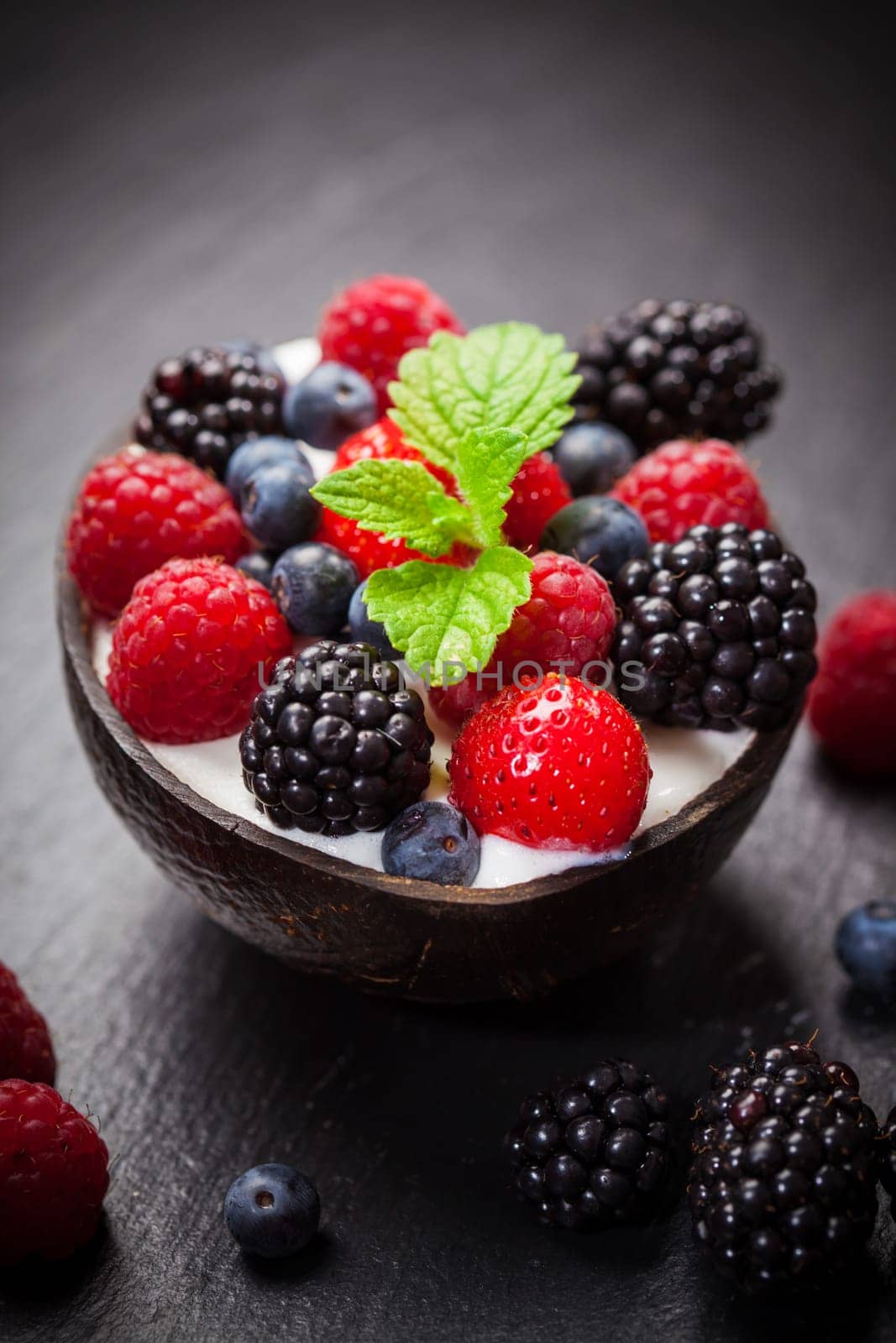 Coconut ice cream with fresh fruits and mint