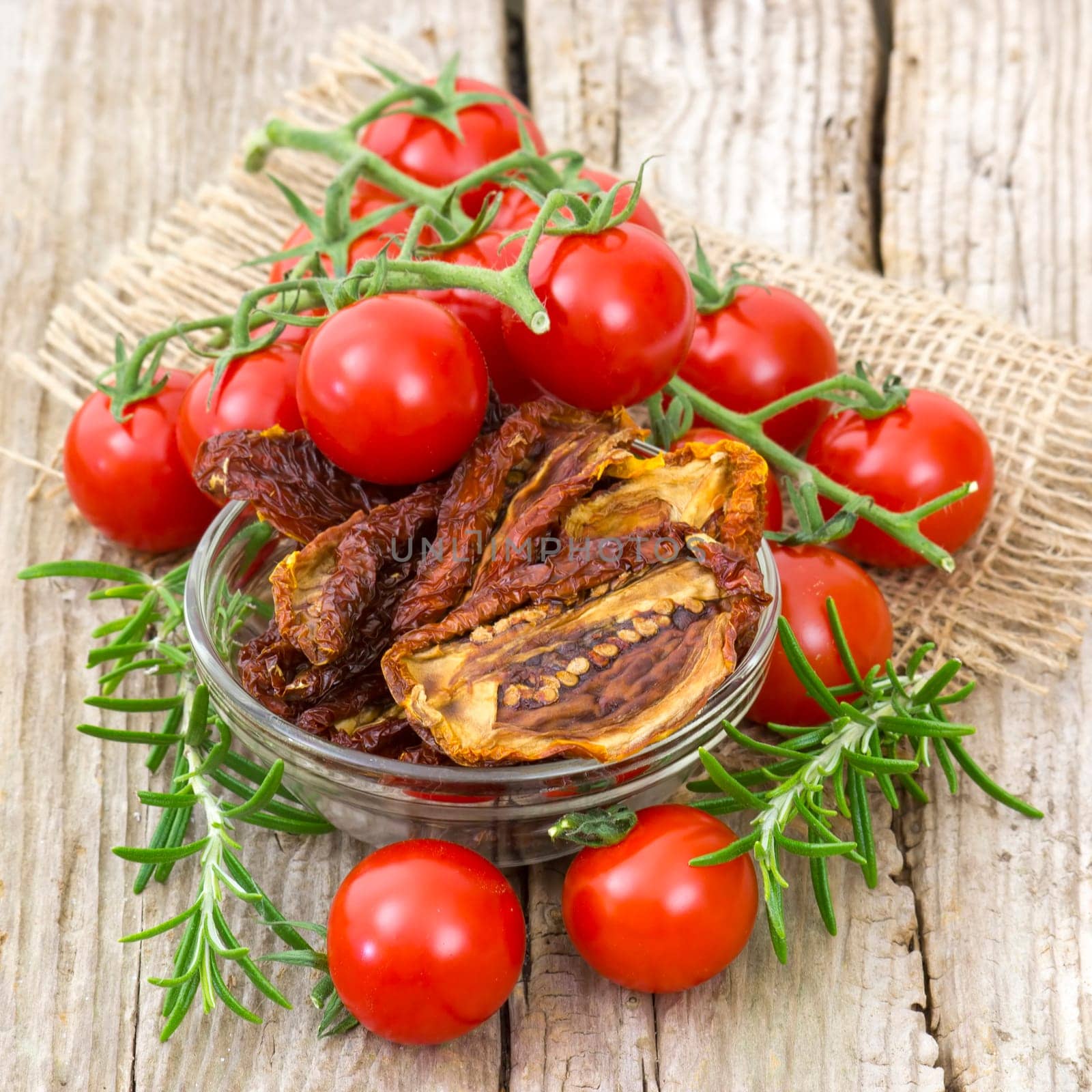 fresh and dried tomatoes on wooden background
