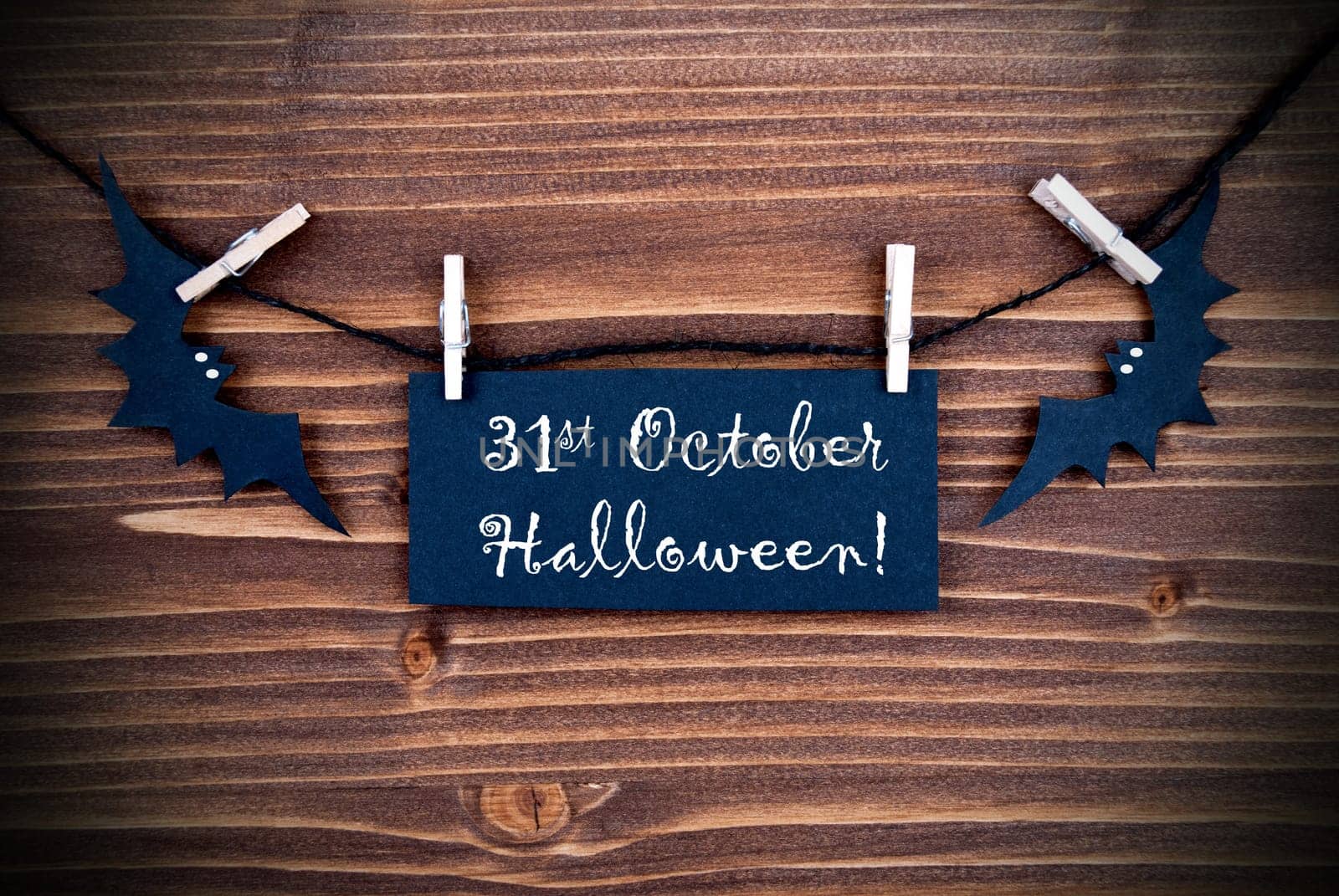 Black Label on a Line with the Words 31st Ocotber Halloween on wooden Background