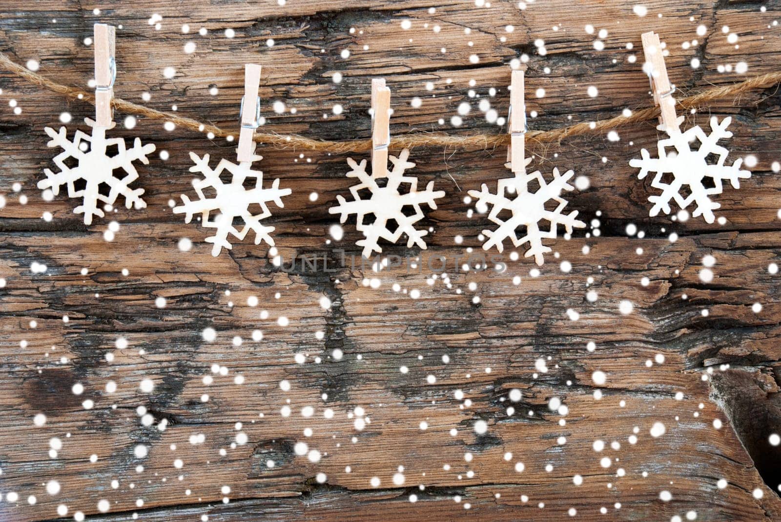 Wooden Snowflakes on a line with Snowflakes on Wood, Christmas or Winter Background