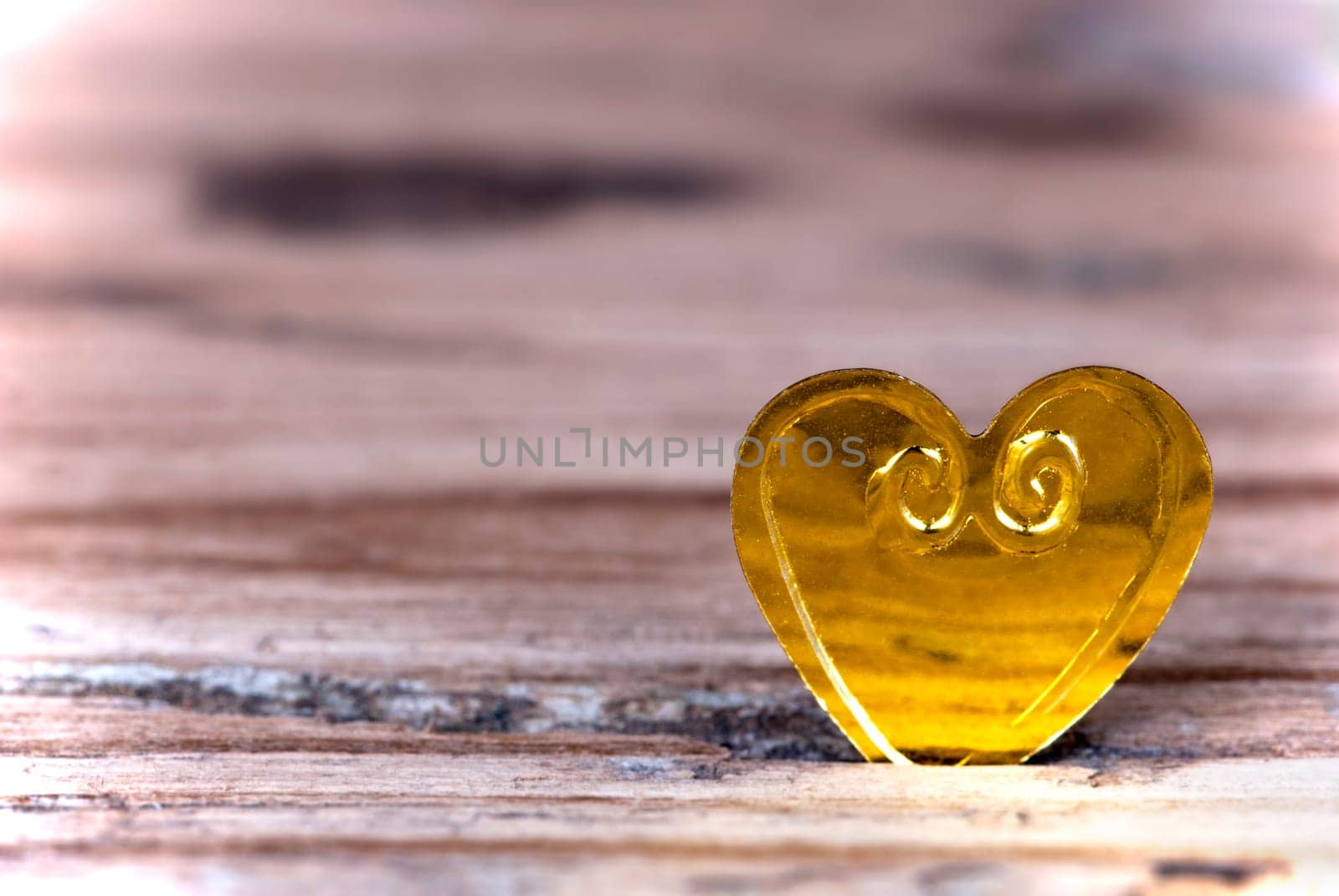 Macro of a Little Heart on a light Wooden Background