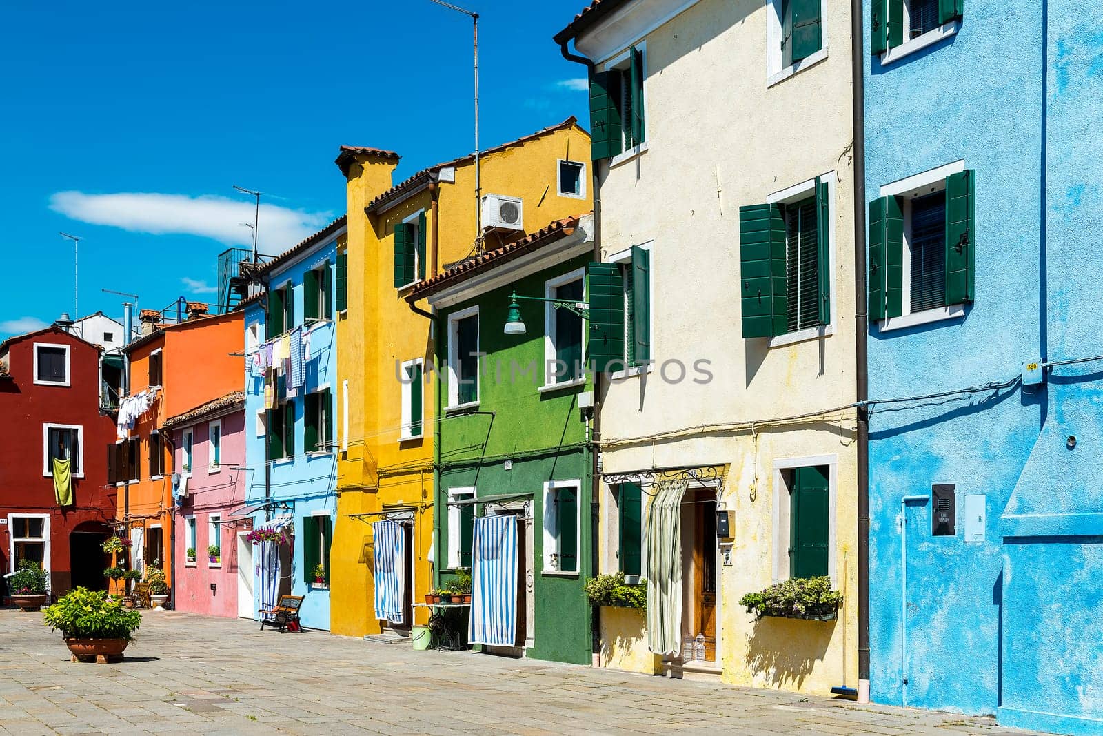 Colorful buildings in Burano island sunny street, Venise, Italy