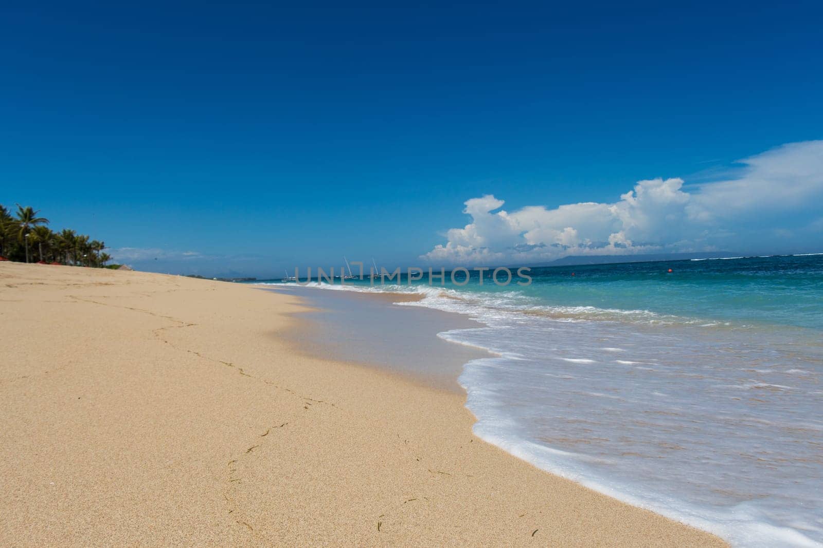 Beautiful secluded sandy beach in the Caribbean with white sand and blue sky as in paradise