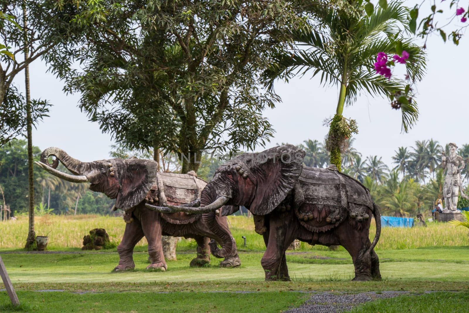 Realistic statue of a bronze elephant in a park in Bali
