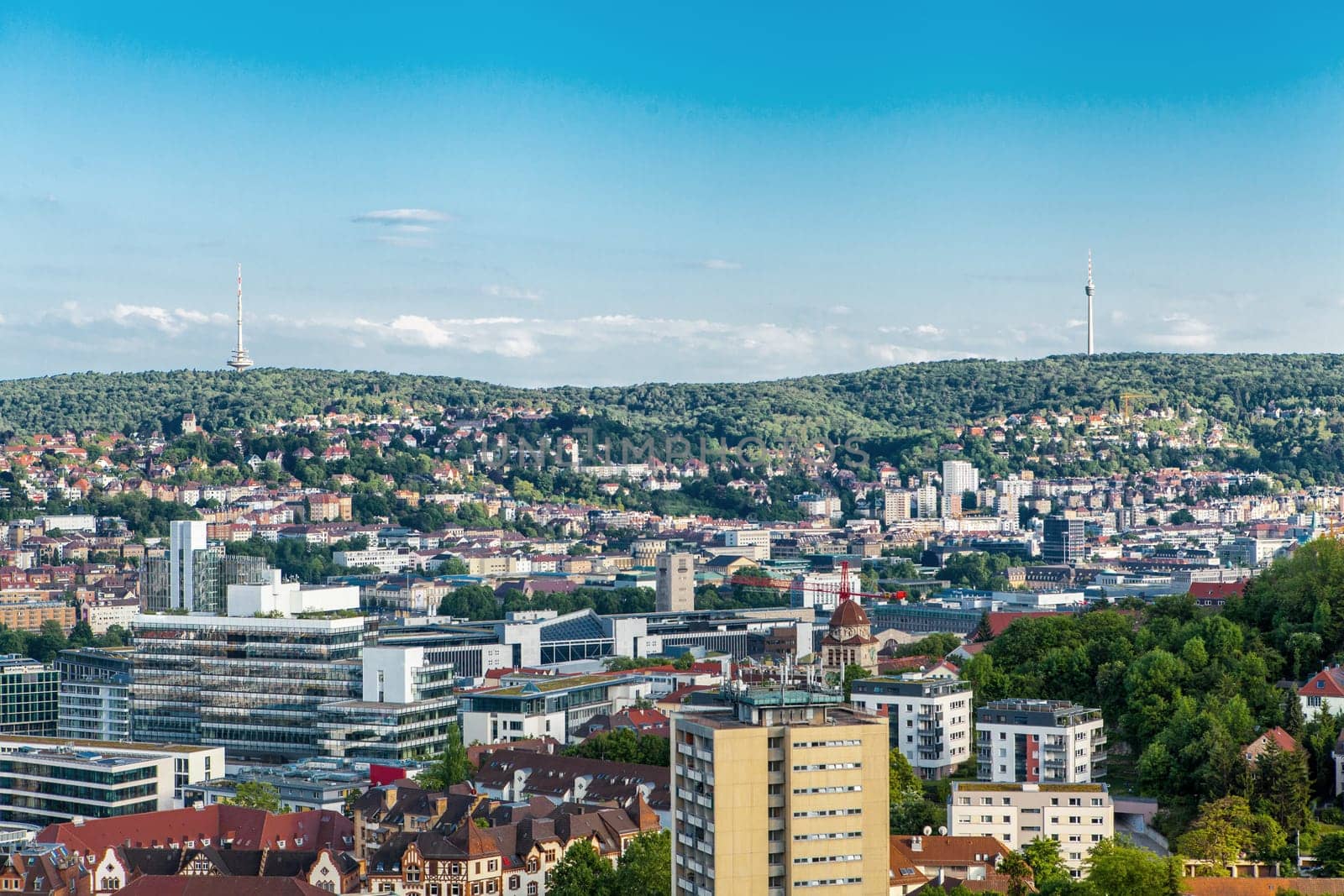 Picturesque view of Stuttgart Germany the modern skyscrapers under the traditional historical architecture overlooking the surrounding hills on a sunny day