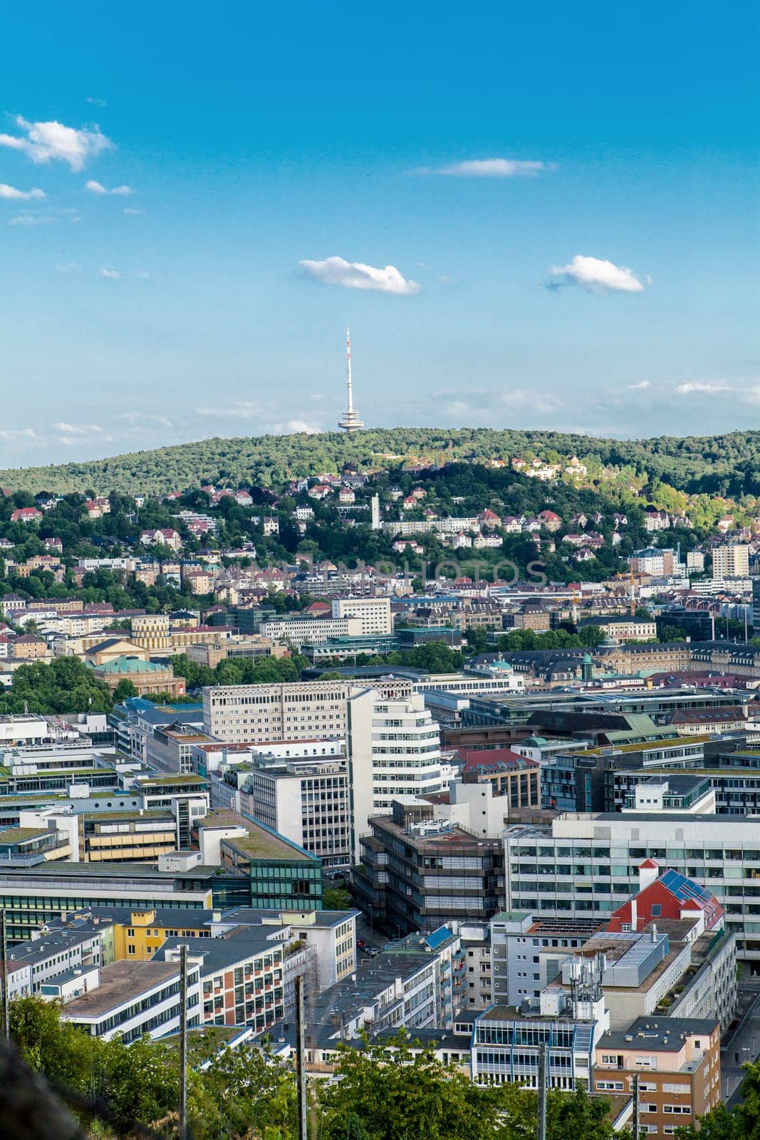 Picturesque view of Stuttgart Germany the modern skyscrapers under the traditional historical architecture overlooking the surrounding hills on a sunny day