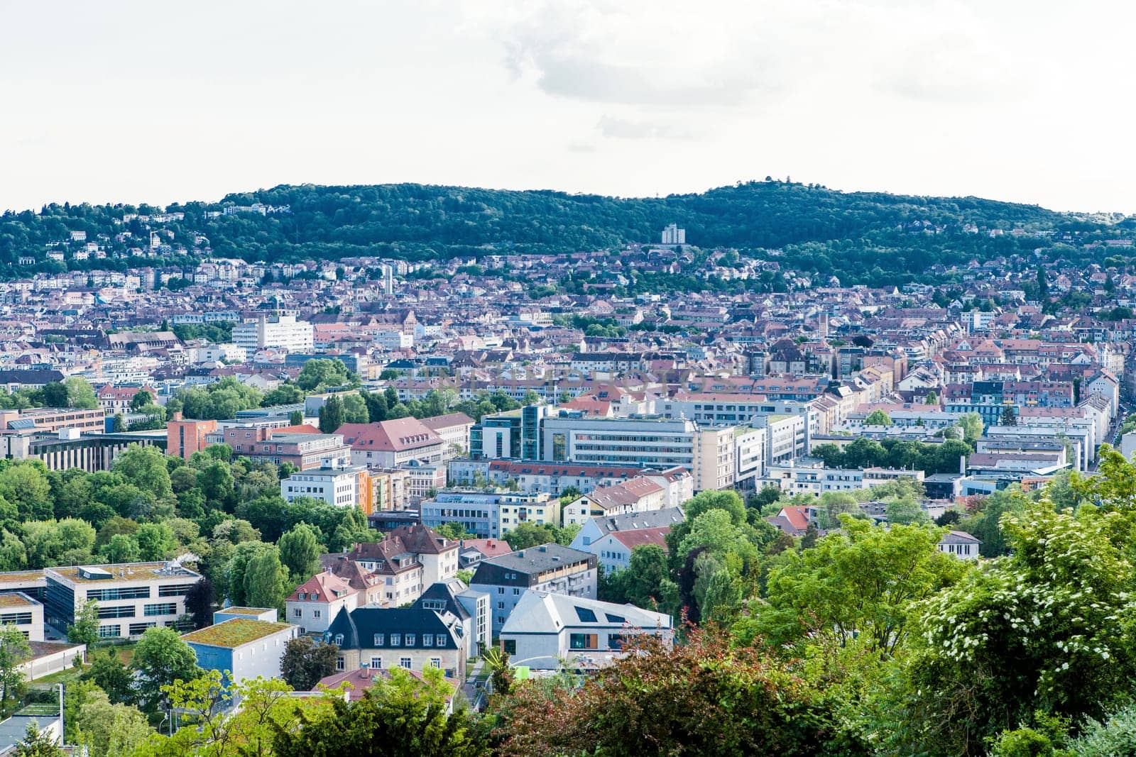 Picturesque view of Stuttgart Germany the modern skyscrapers under the traditional historical architecture overlooking the surrounding hills on a sunny day