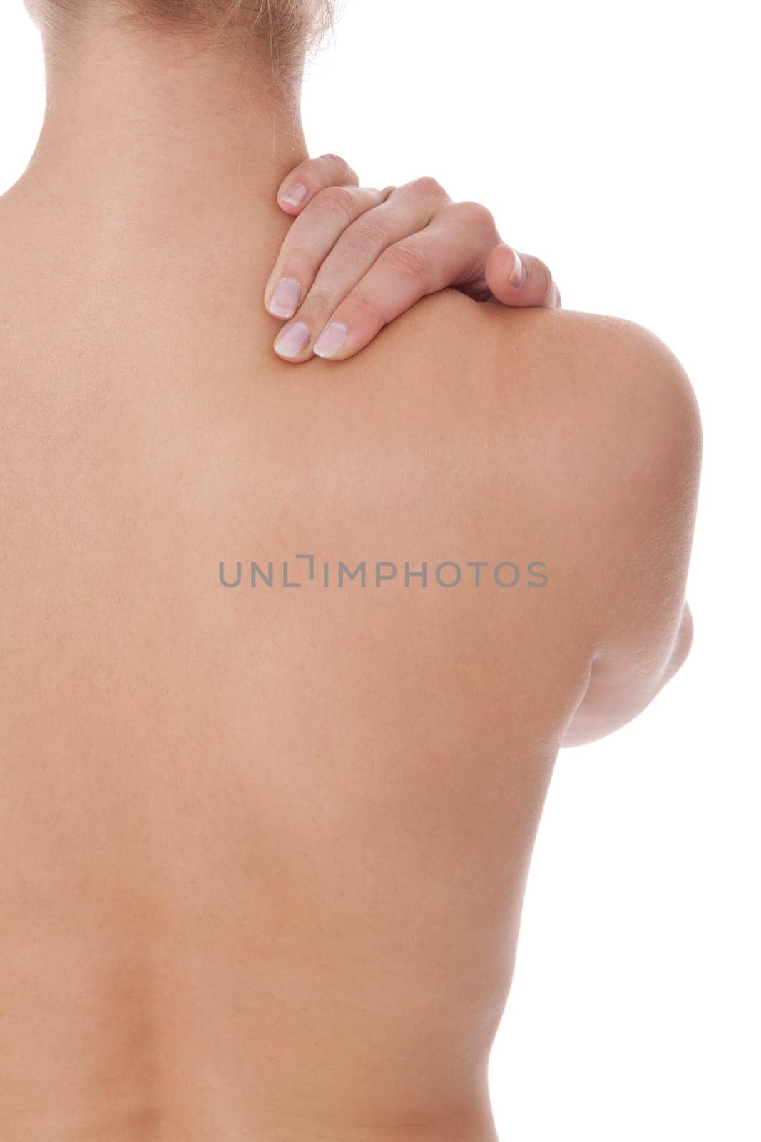 Young attractive woman grabs with her hands on her back bodypart isolated voe white background
